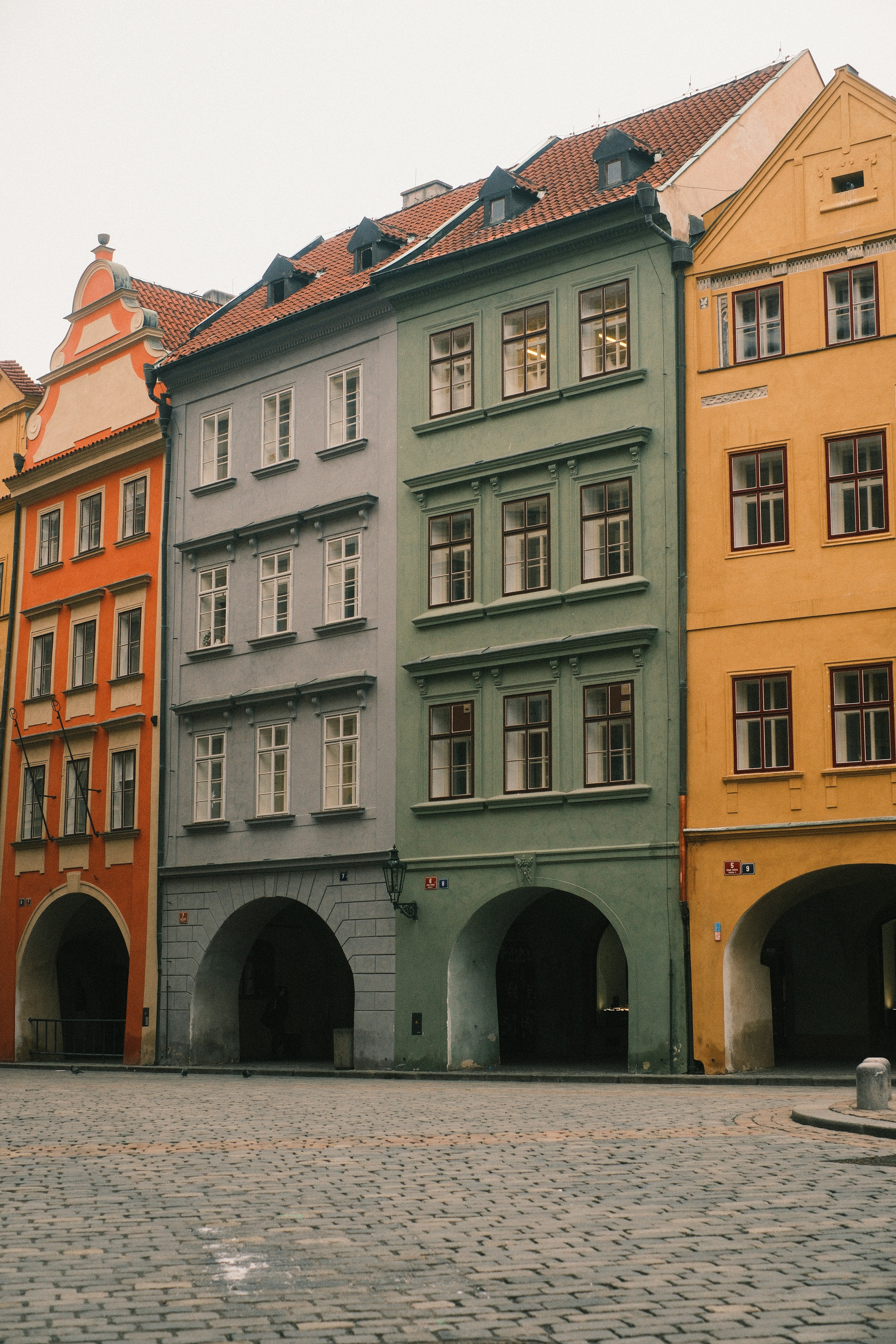 Colorful old buildings with arched doorways and cobblestone street