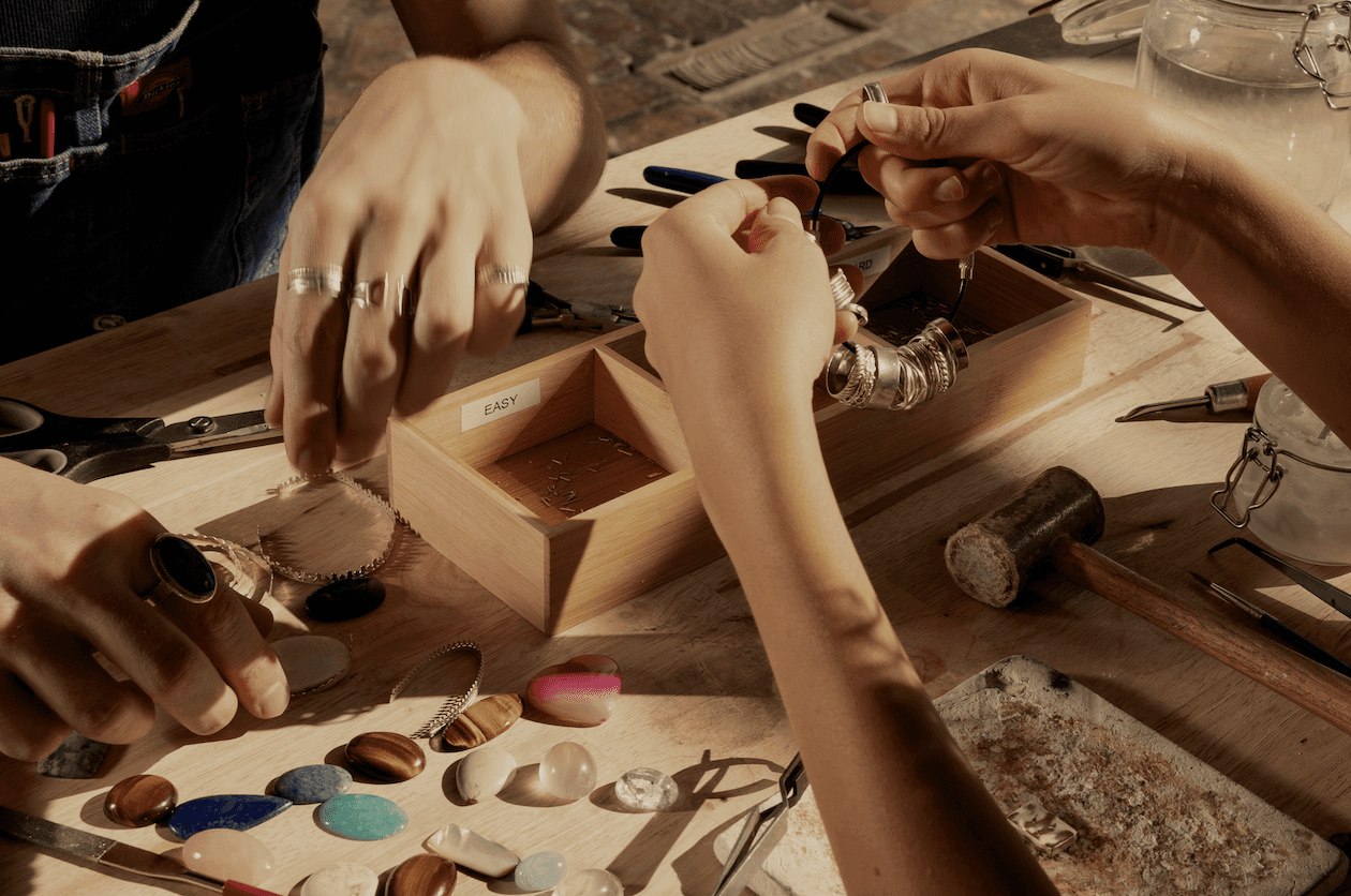 Hands working on jewelry in a workshop