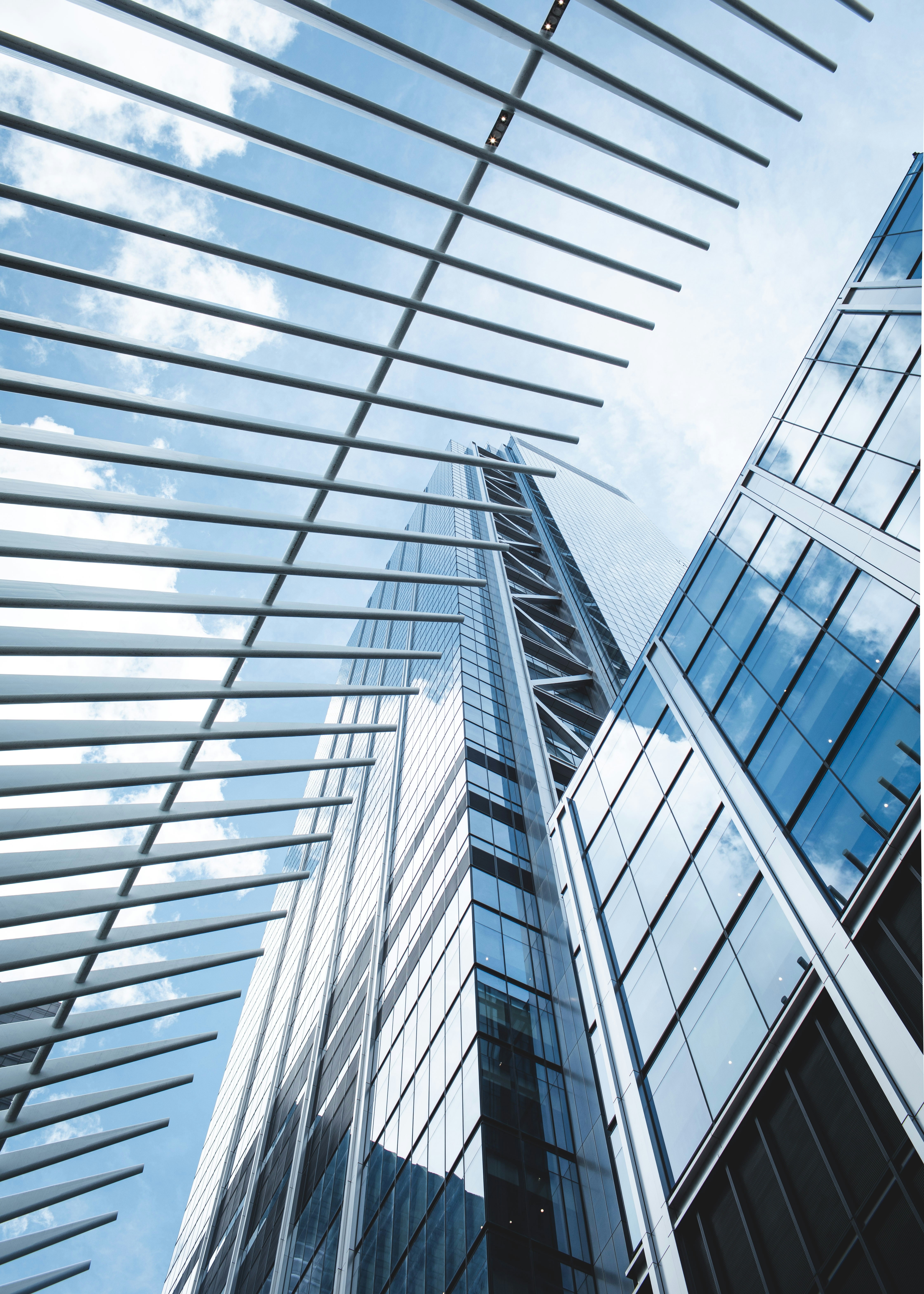 a tall building with many windows and a sky background