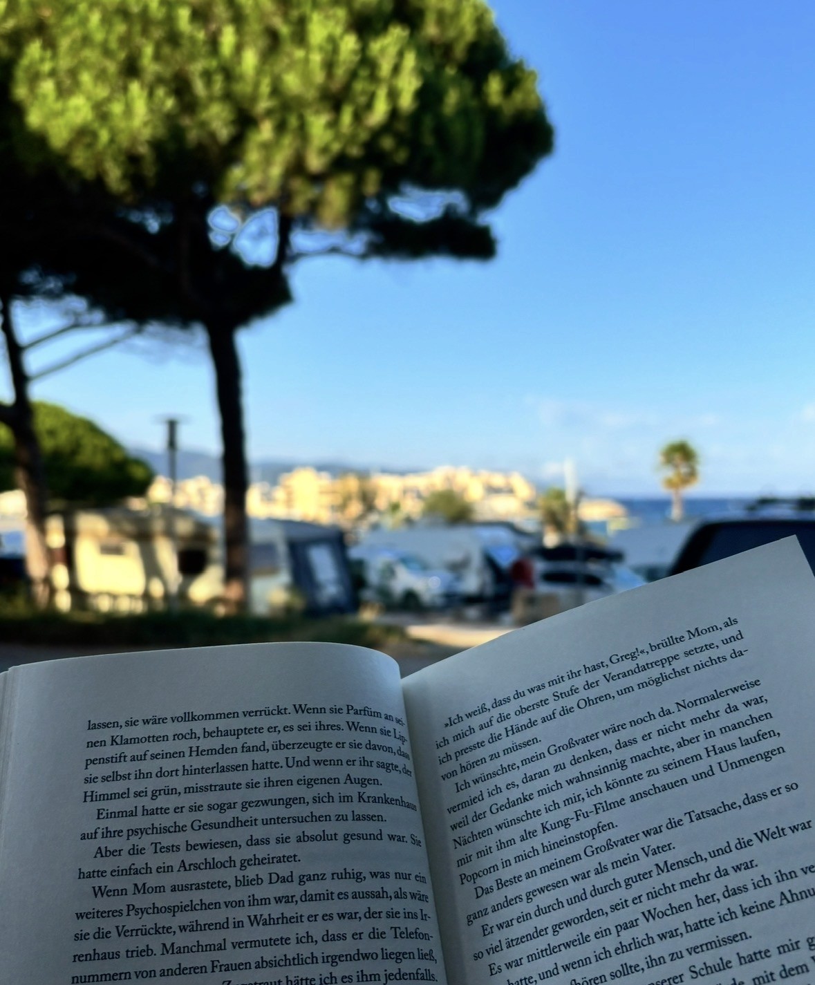 a tablet sitting on top of a table next to a pile of books