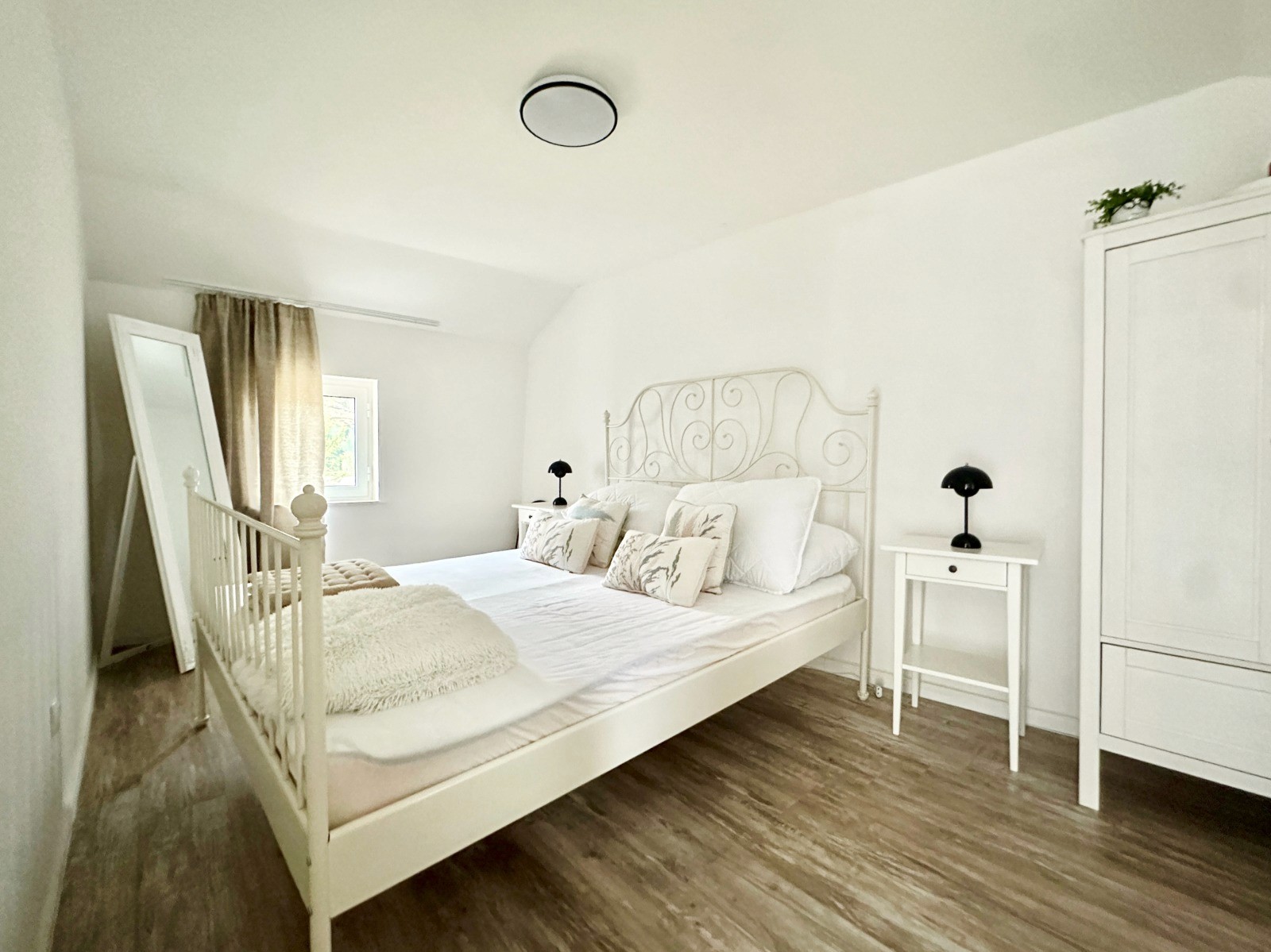 Black sports car in front of a modern, futuristic curved building.