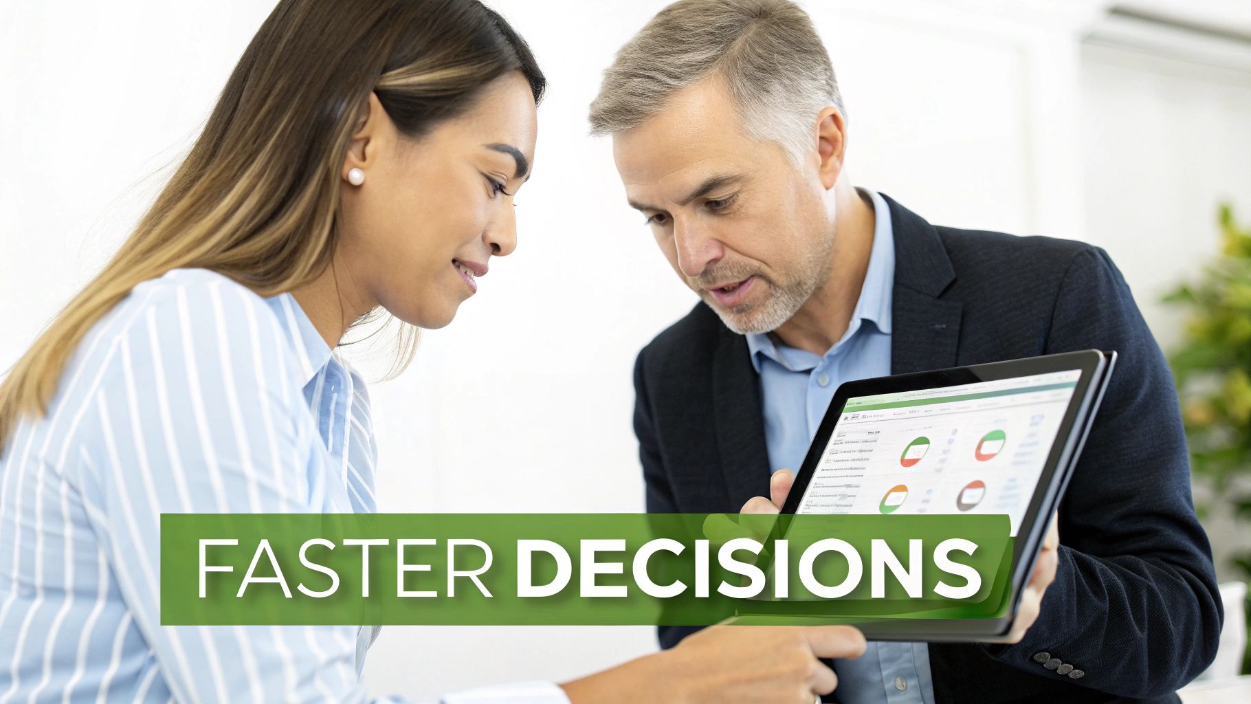 Two business professionals analyzing data on a tablet, symbolizing faster decision-making.