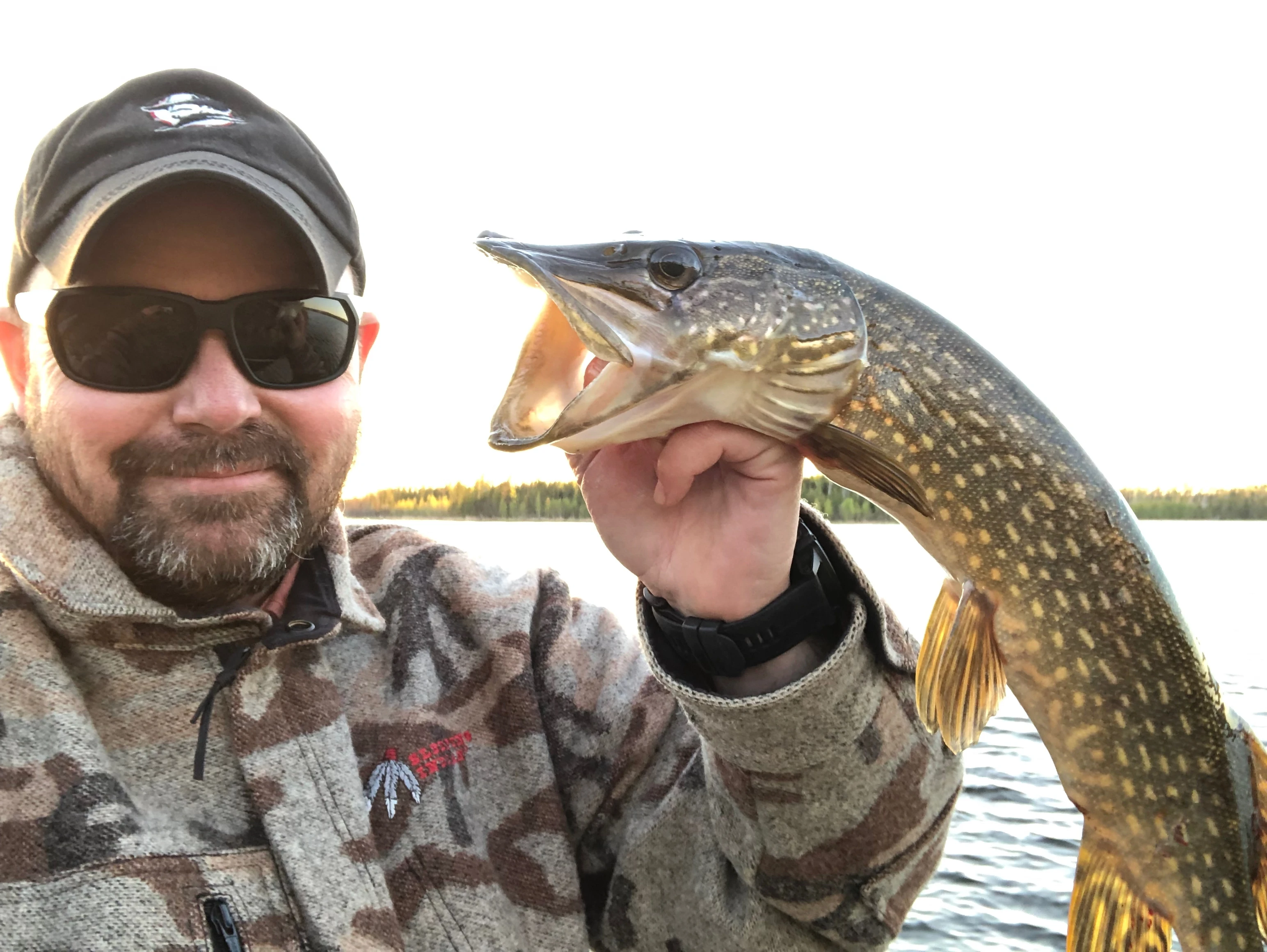 Person holding a fish outdoors