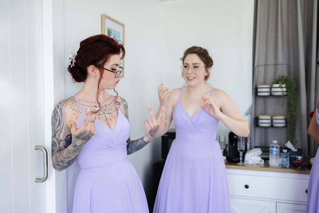 Bridesmaids in purple dresses dancing together