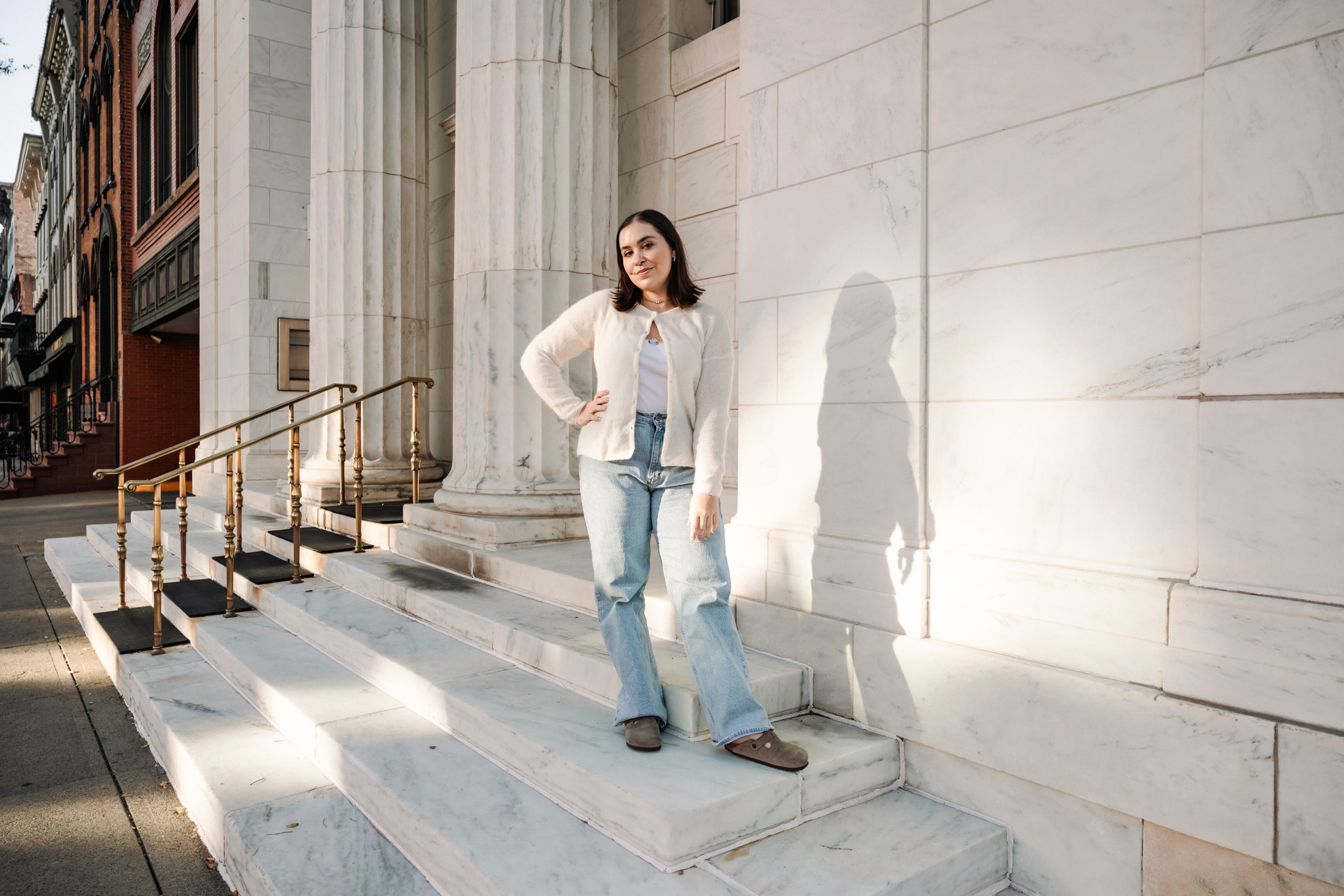 6:13 PMNewly engaged couple sitting on a stoop in the West Village, NYC bathed in warm golden hour light — romantic, candid golden hour engagement photography by Lizz Spano Photography, New York City engagement photographer.