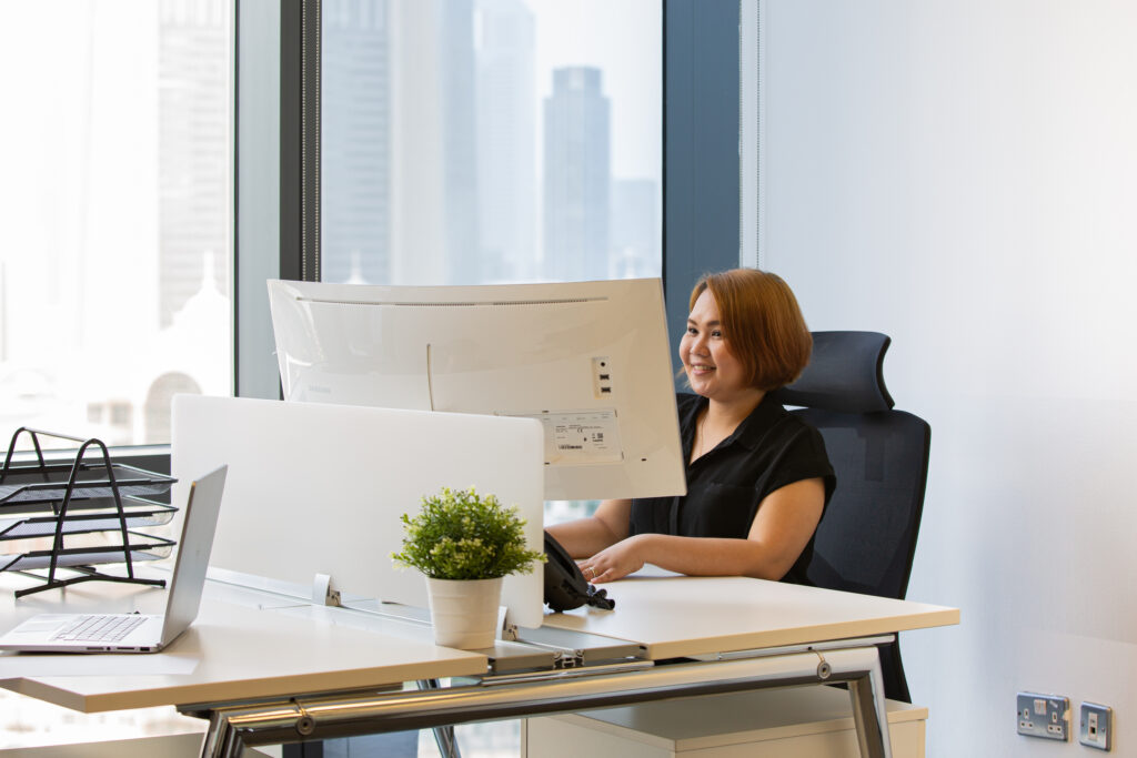 A corporate lady working at a desktop in myOffice.&nbsp;