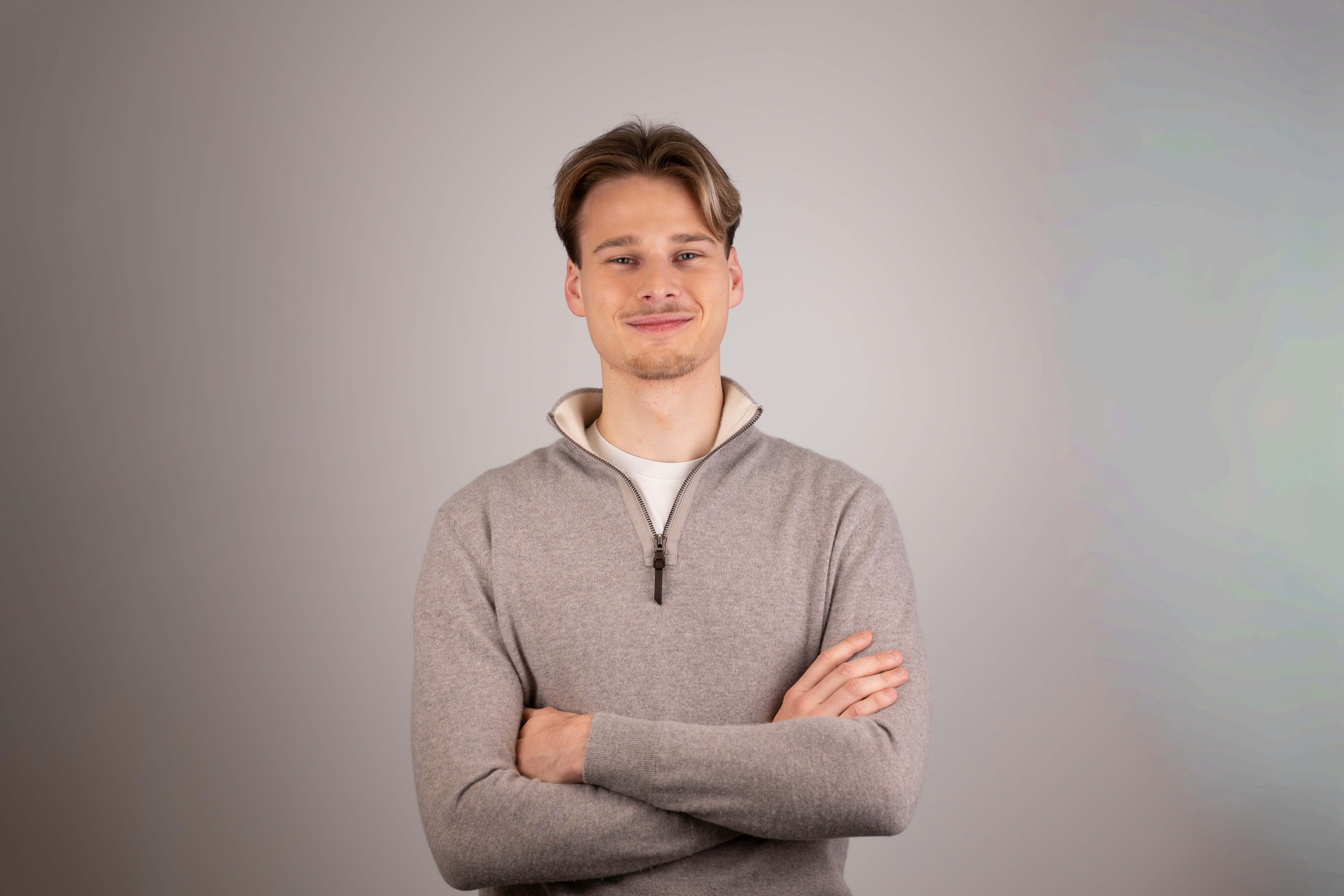 Portrait of a person in dark clothing speaking on a phone