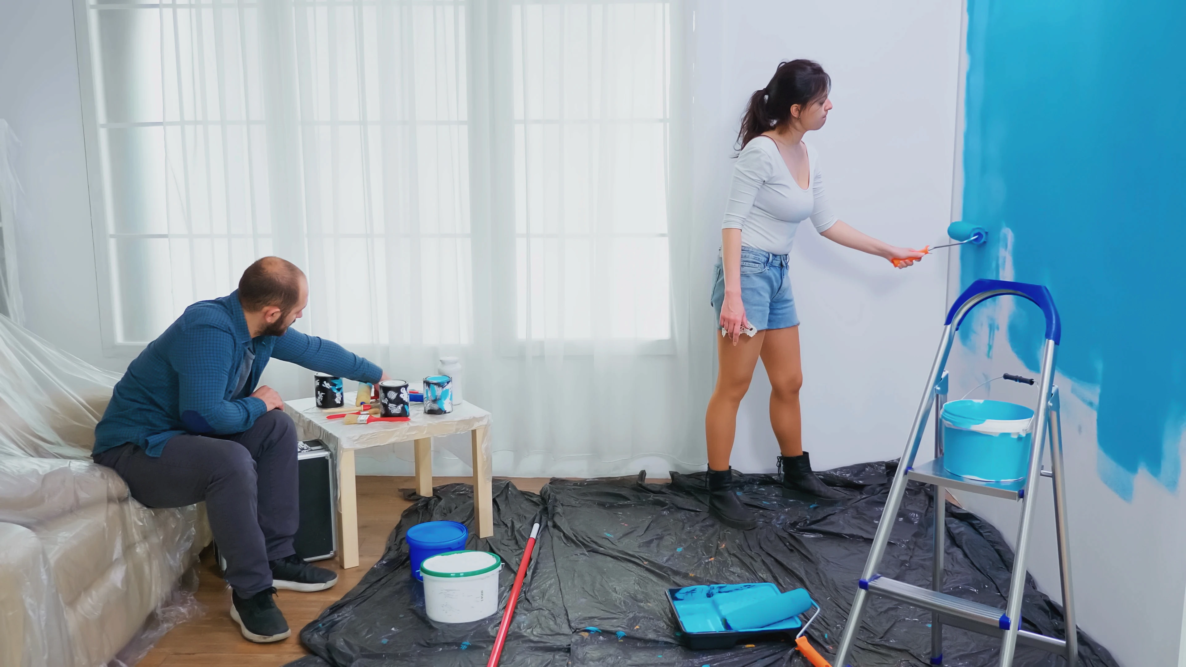 wife-painting-wall-with-roller-brush-home-decorating-couple-home-decoration-renovation-cozy-apartment-flat-repair-makeover