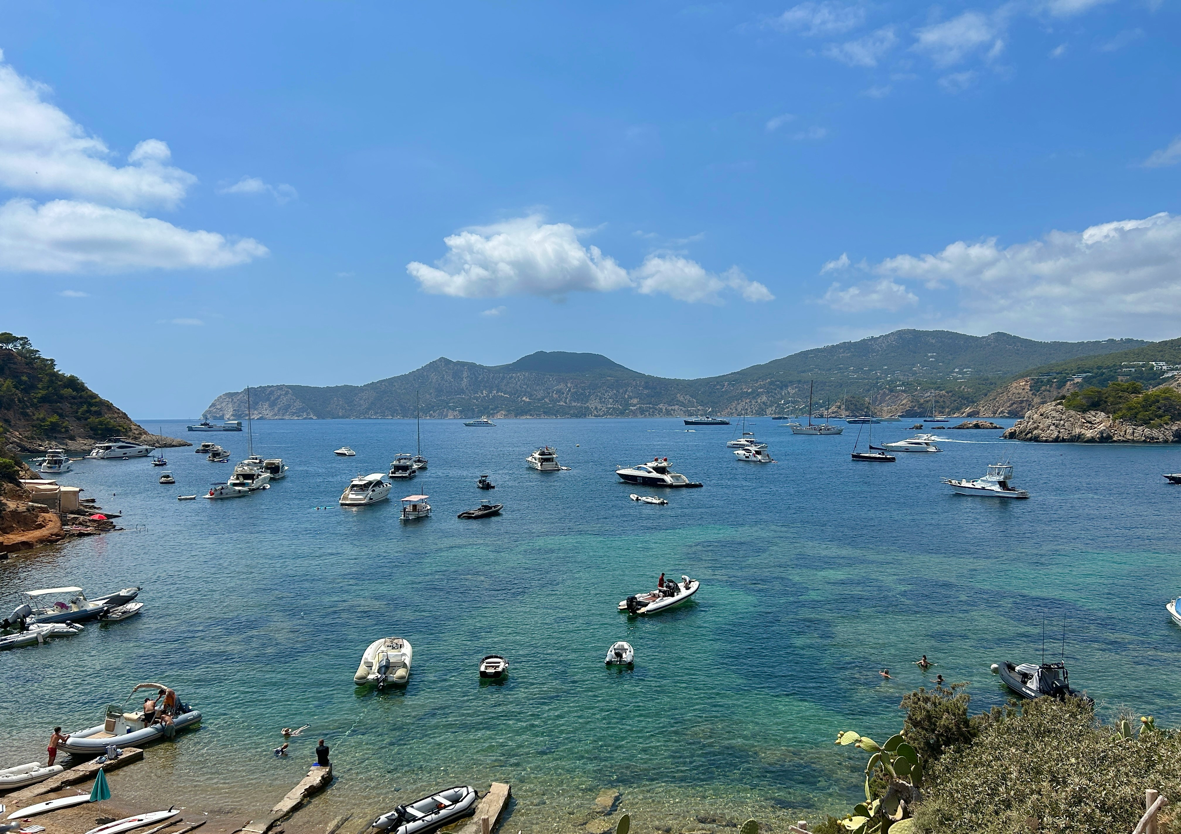 a group of boats floating on top of a body of water
