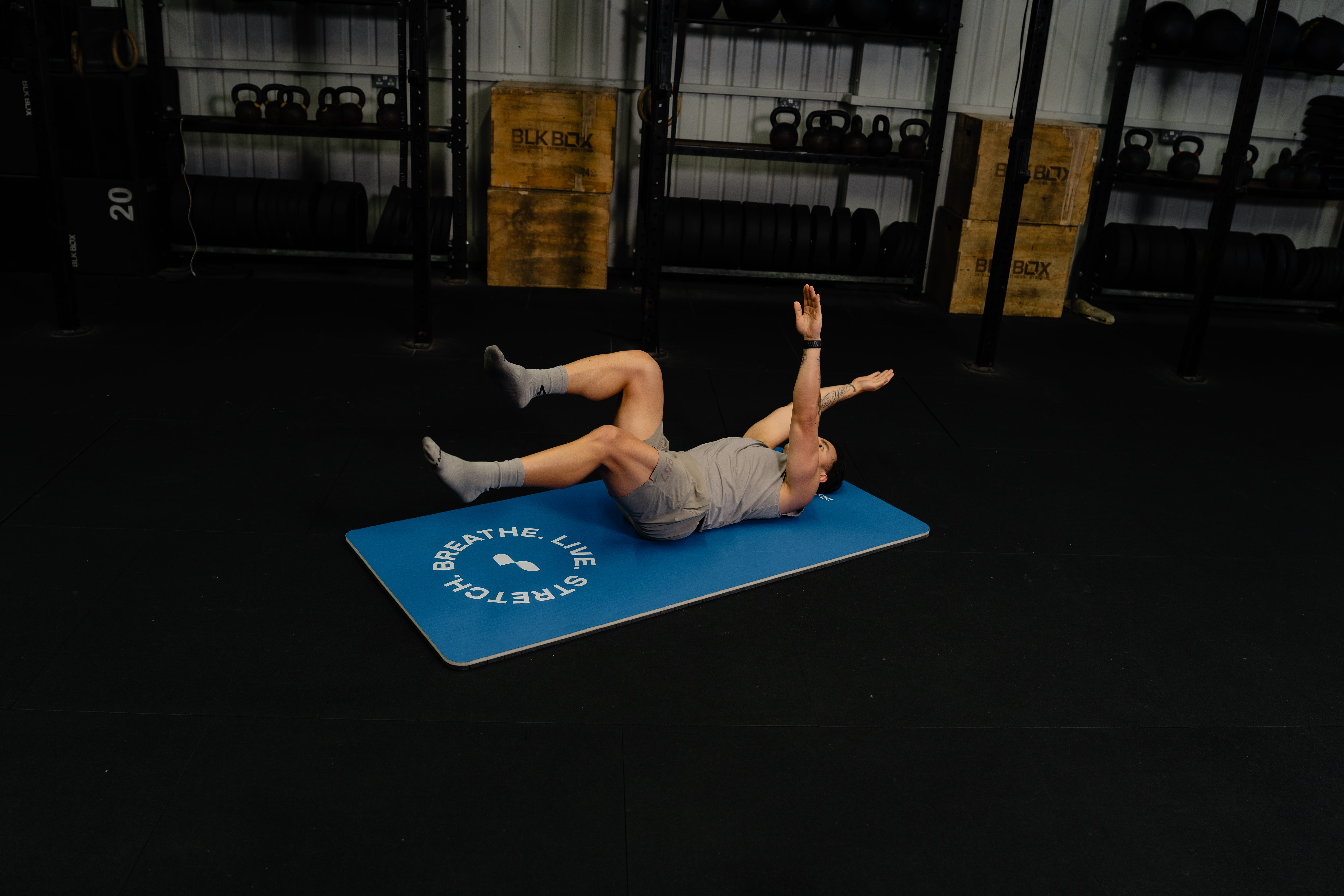man with back on mat - How Does Sleep Affect Athletic Performance