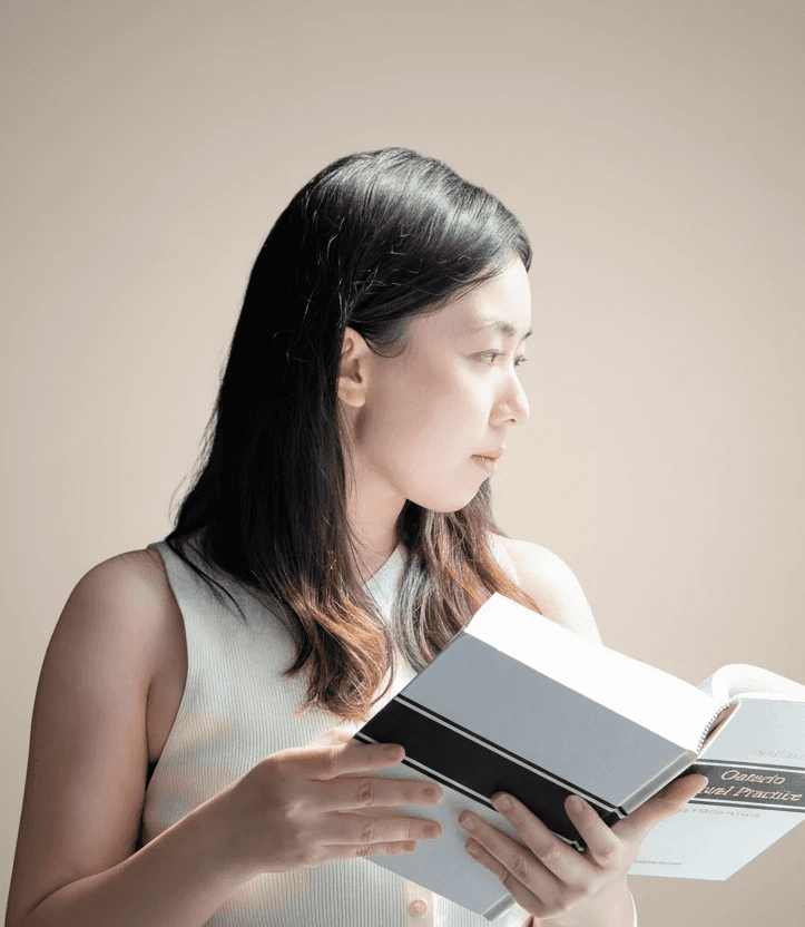 Female looking right at a book