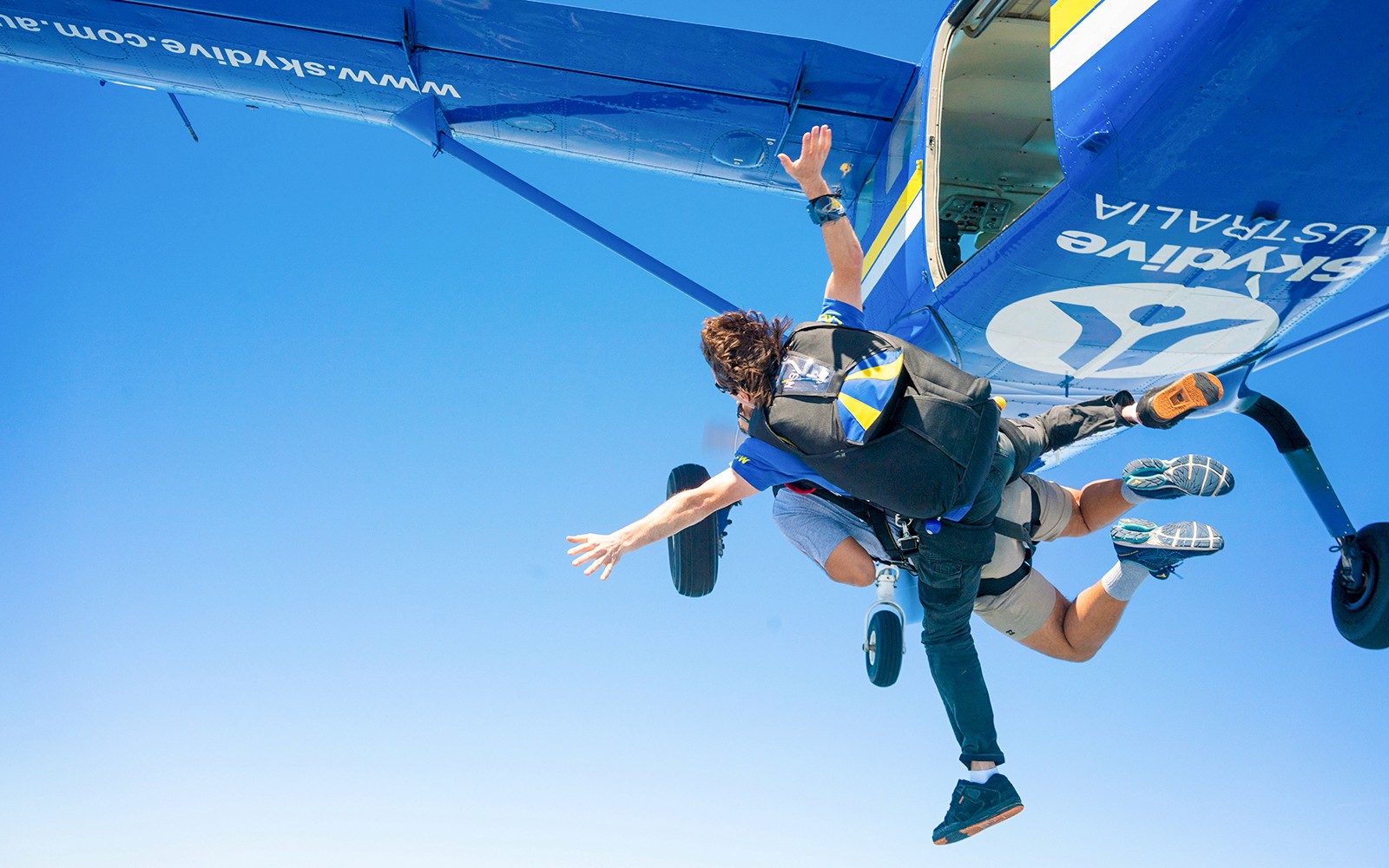Paracadutisti in tandem che saltano dall'aereo sopra Newcastle.