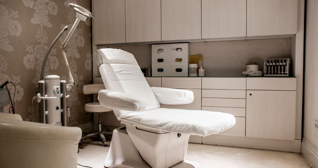 Medical aesthetic clinic treatment room with chair and equipment