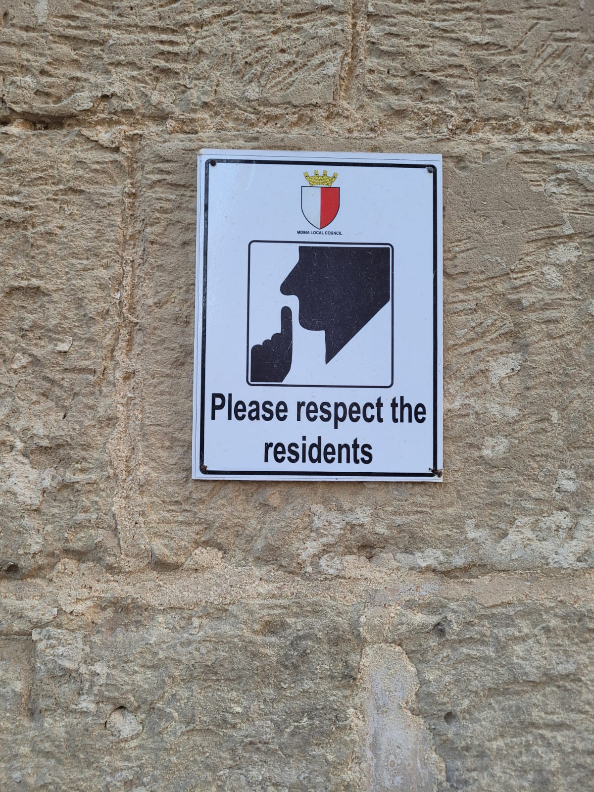 a brown dog sitting on top of a sandy beach