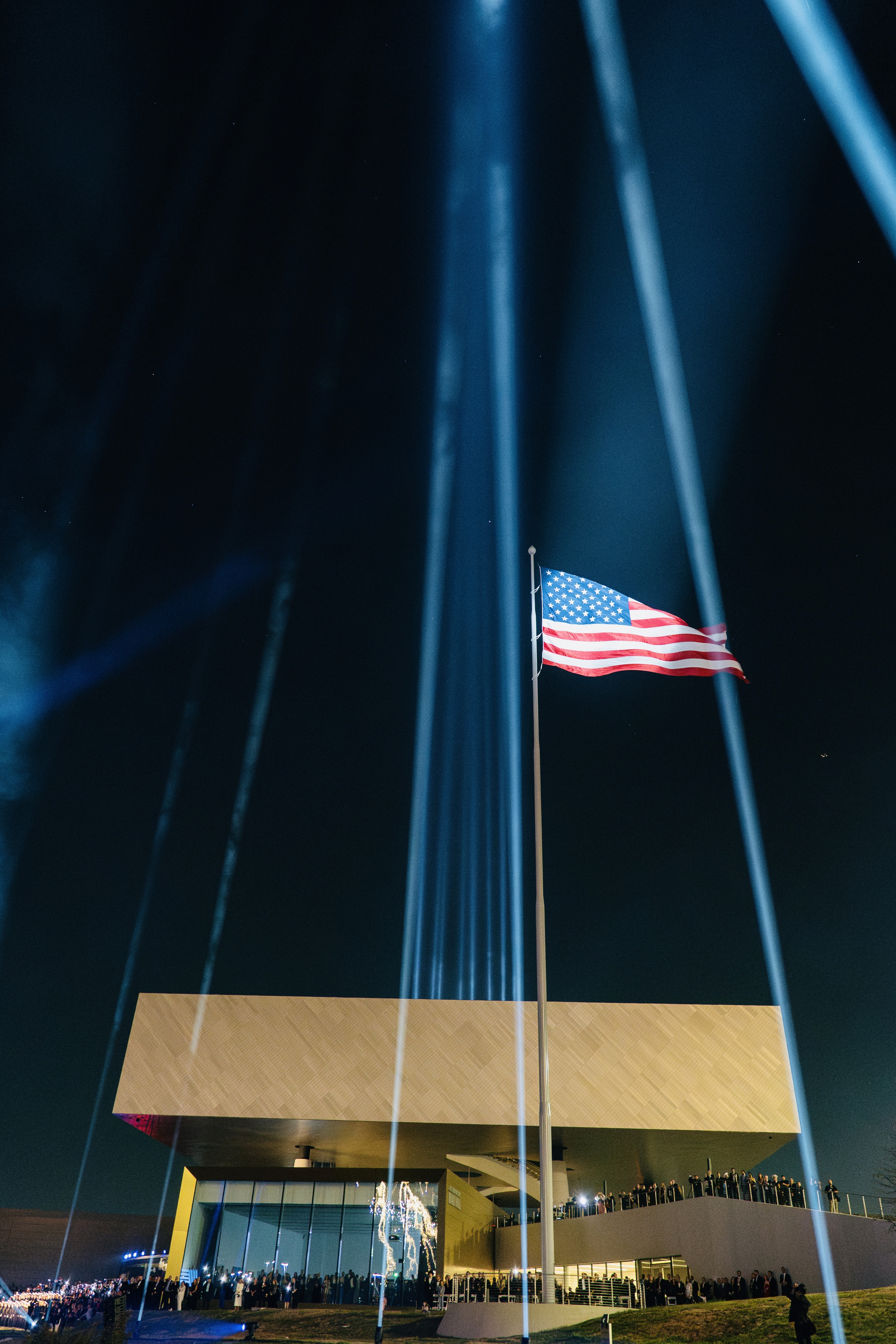 Light beams shining up on the American Flag poised over the National Medal of Honor Museum