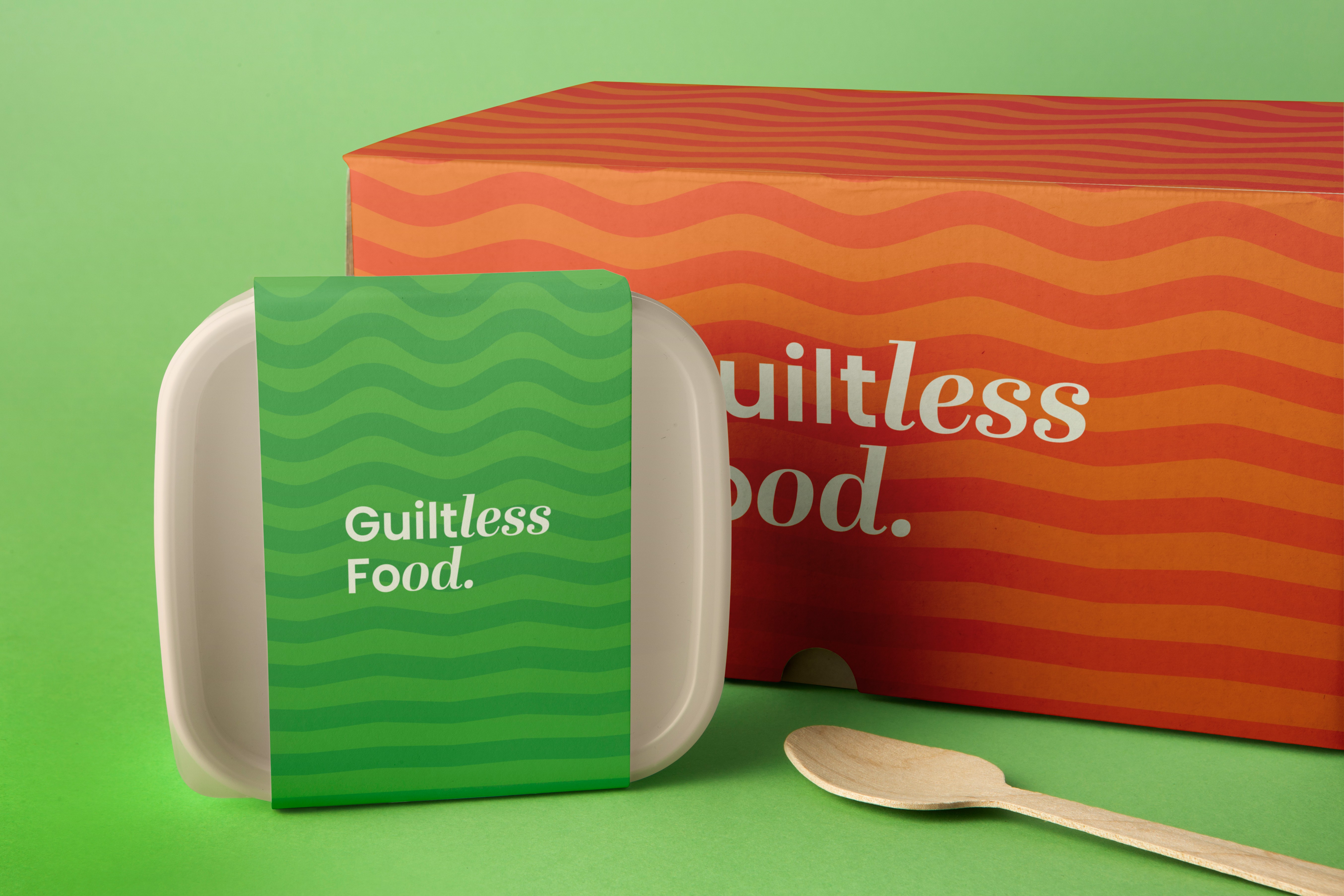 Healthy Vibes green food container and orange patterned packaging carrying the Guiltless Food message.