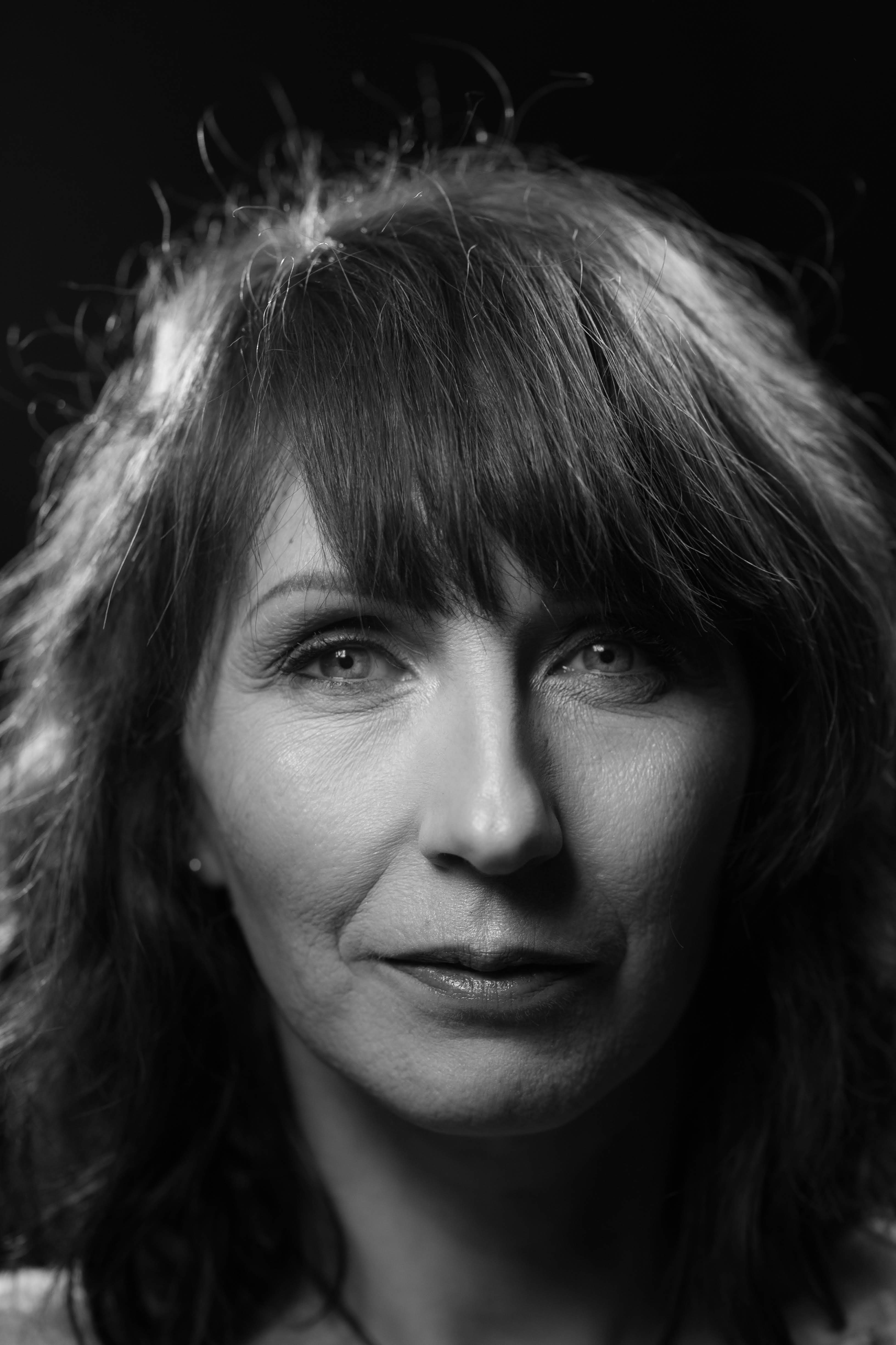 People playing soccer on a rooftop court surrounded by city buildings