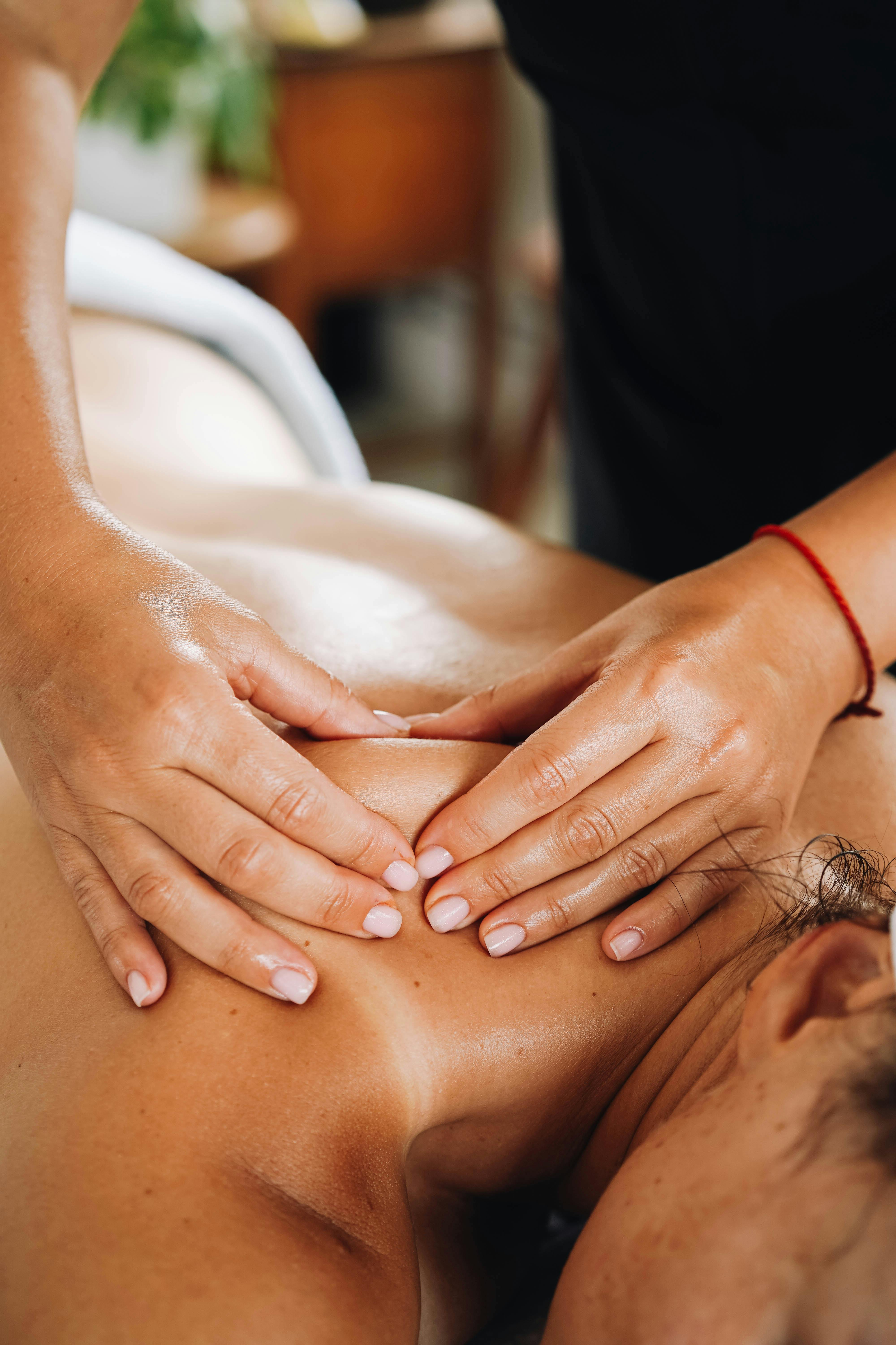 a woman getting a back massage at a spa