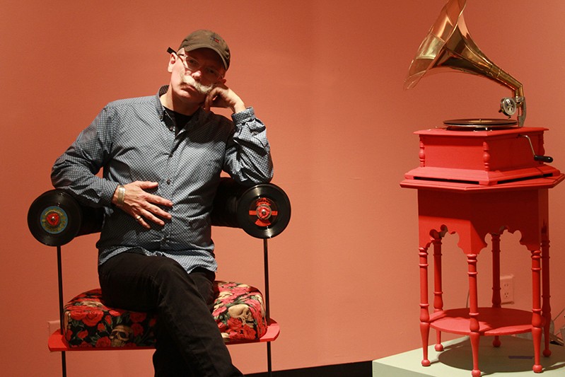a man sitting on a flower bottom chair