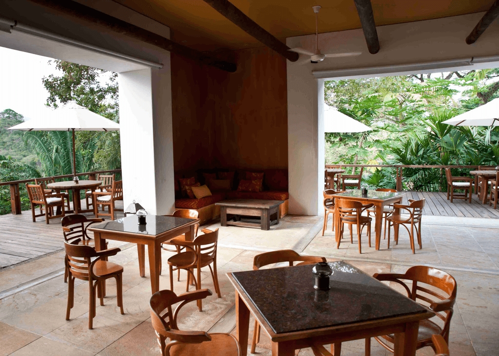 Unique concrete and earth-covered building entrance in a dry, sunny landscape.