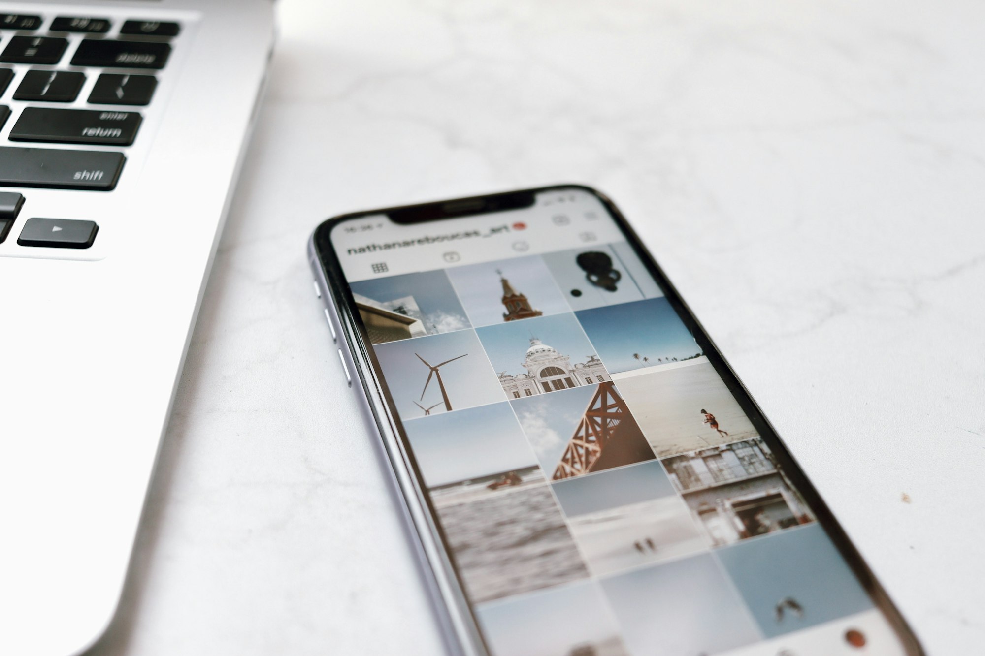 smartphone on white table showing instagram media feed