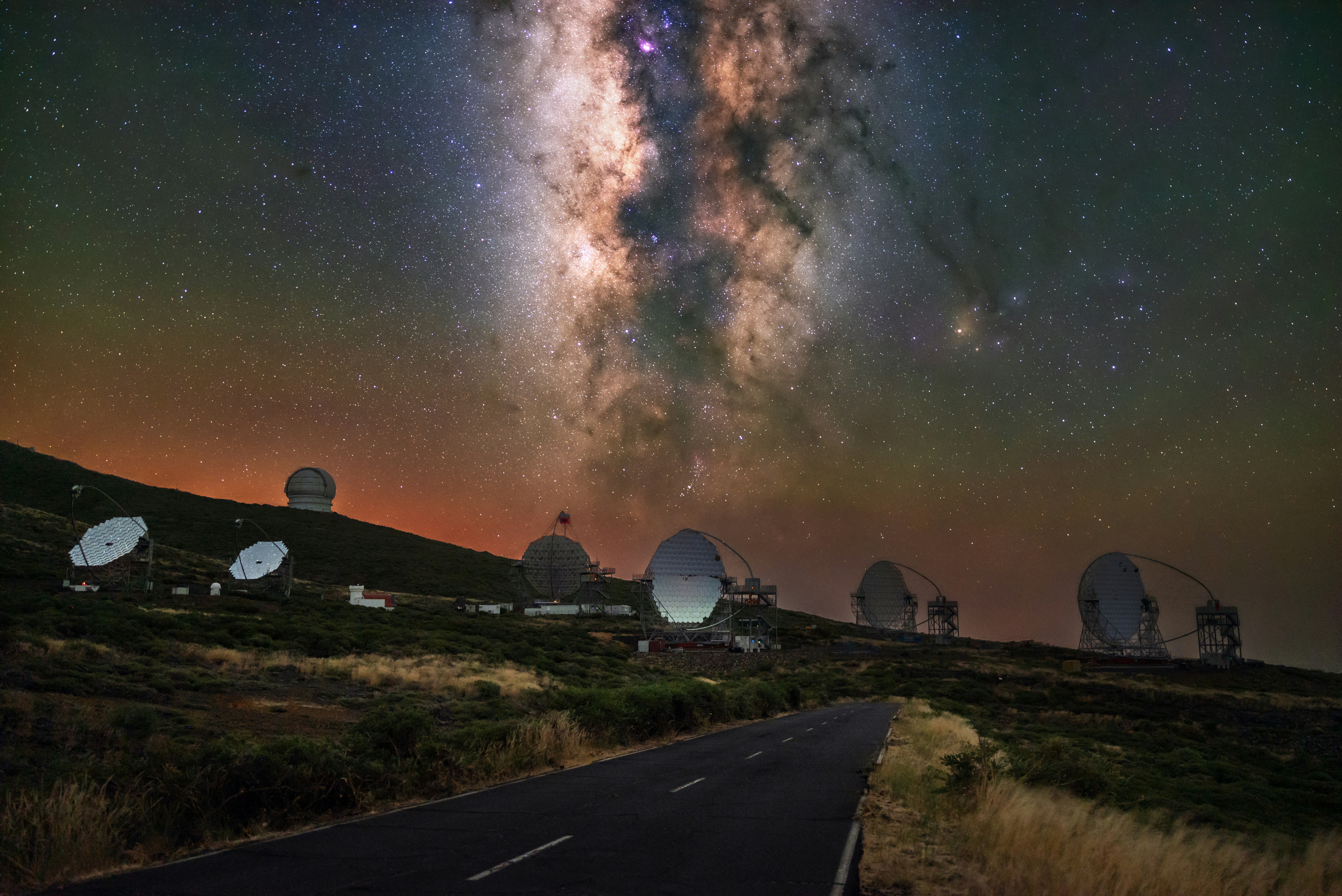 Observatory domes under the milky way at night.