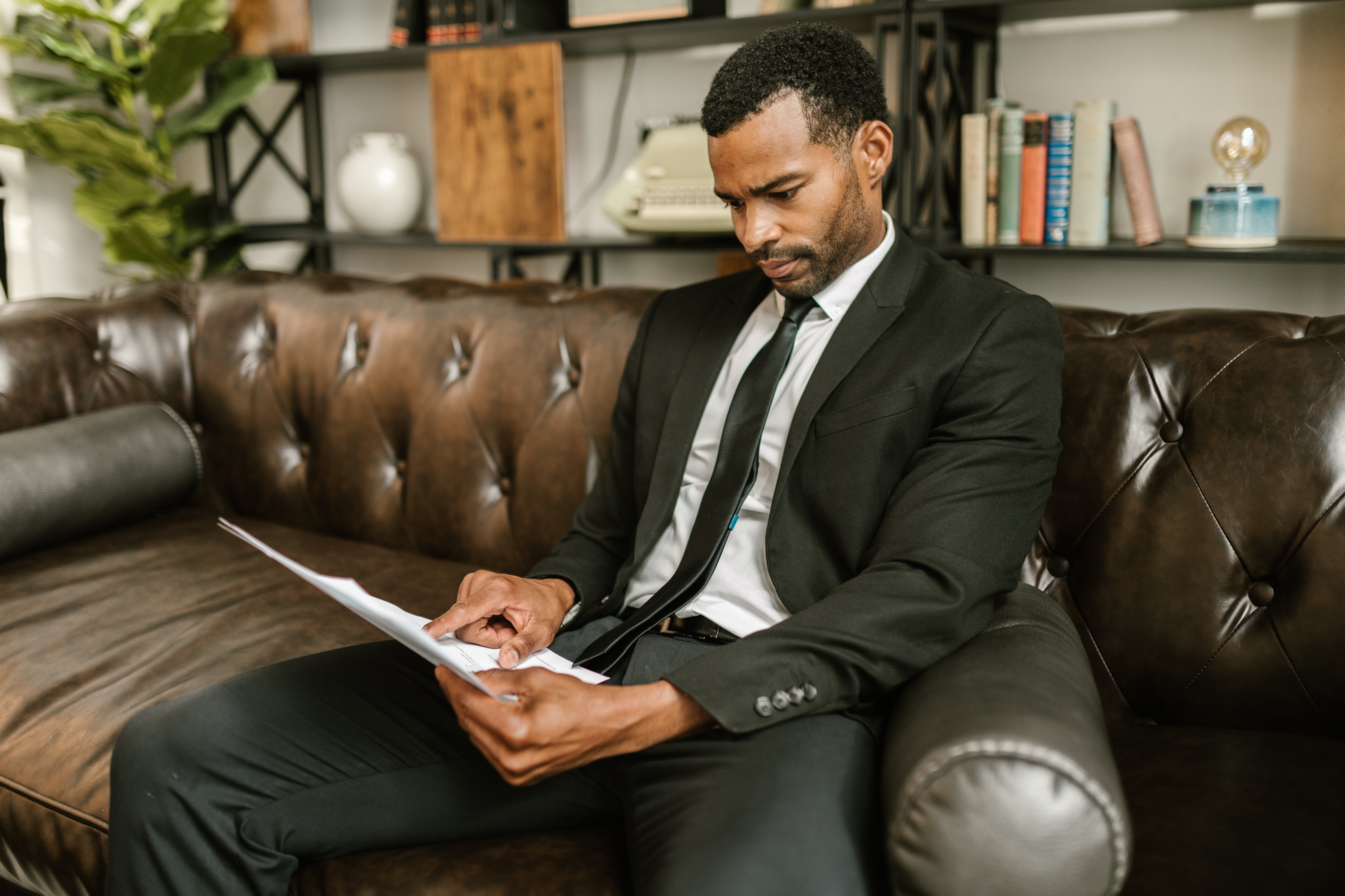 Man applying for a mortgage sitting on a couch