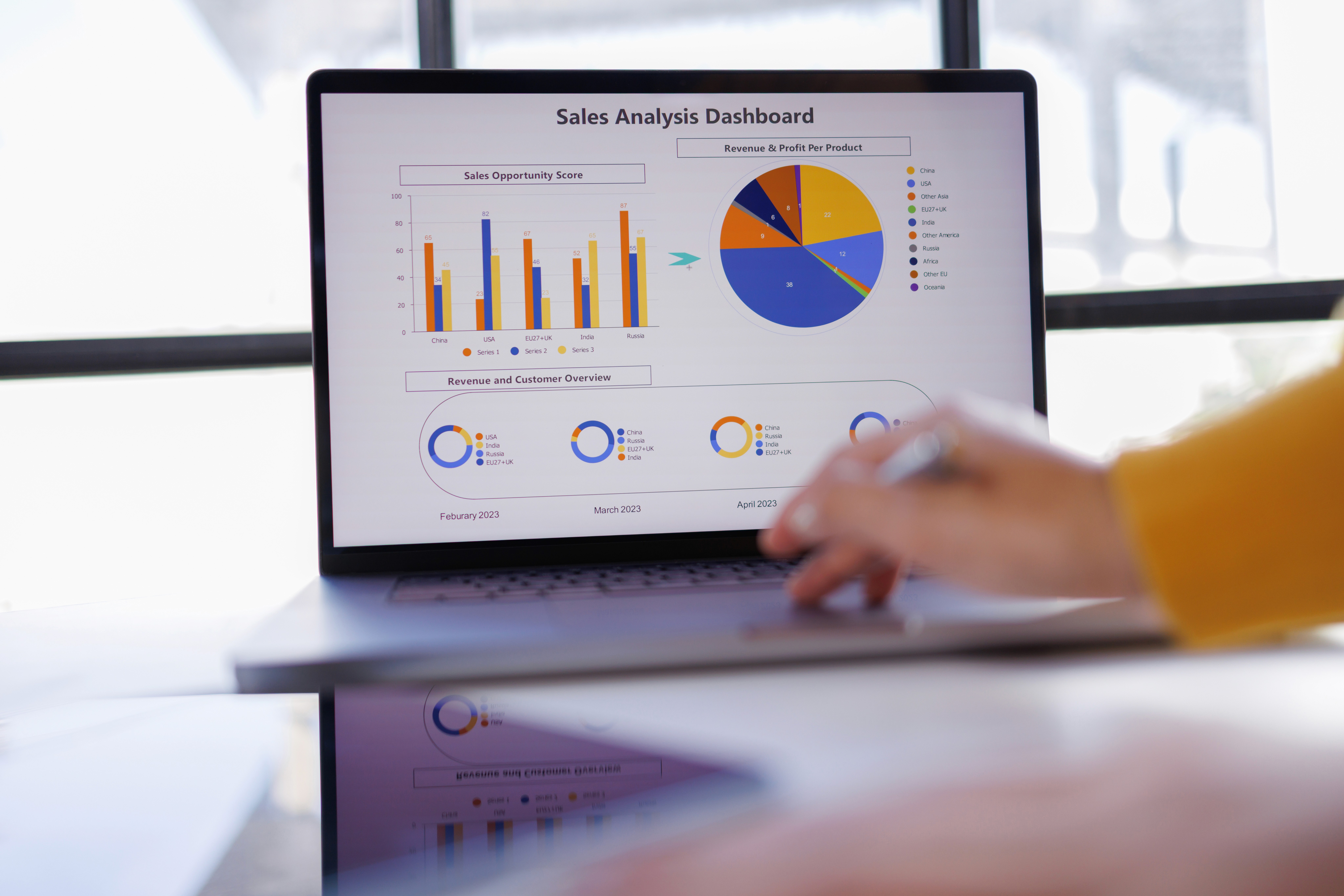 Aerial view of a winding road cutting through rocky terrain with patches of grass.