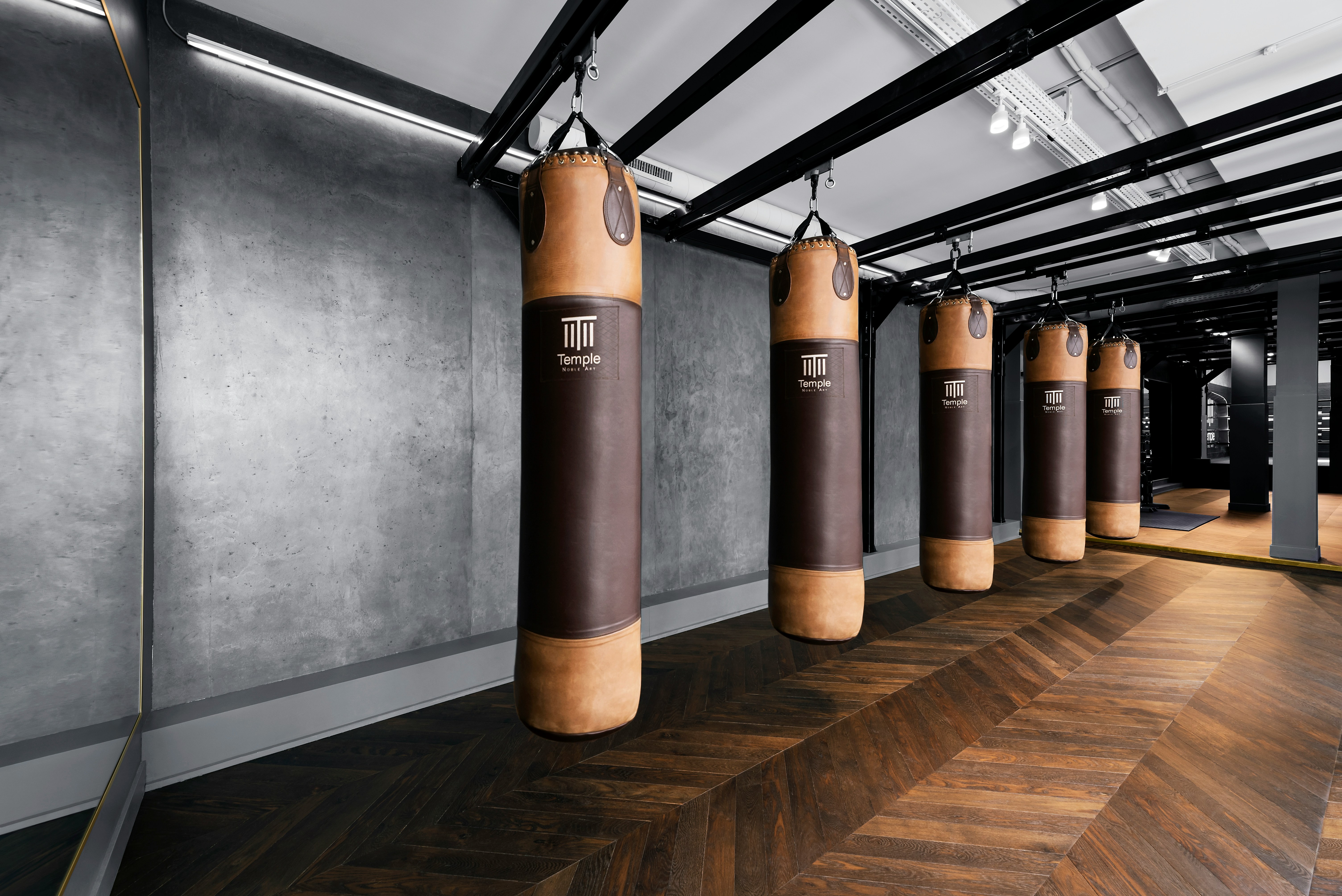 a row of punching bags in a gym