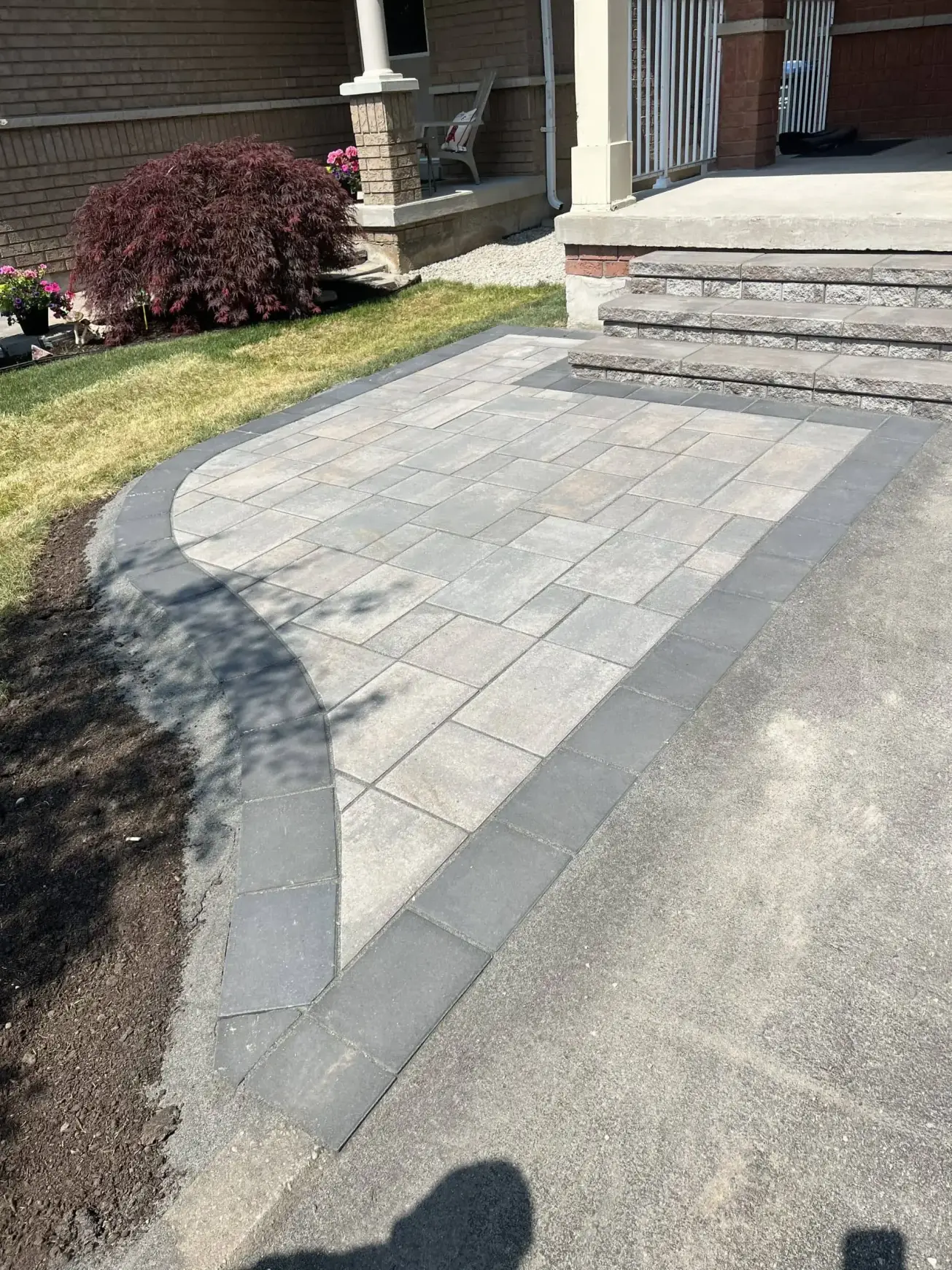 “Falcons Landscaping hardscape design featuring grey interlocking stone with a border finish.”