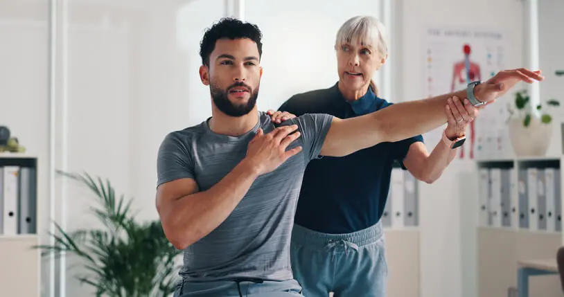 Physical therapist assessing a patient’s knee movement