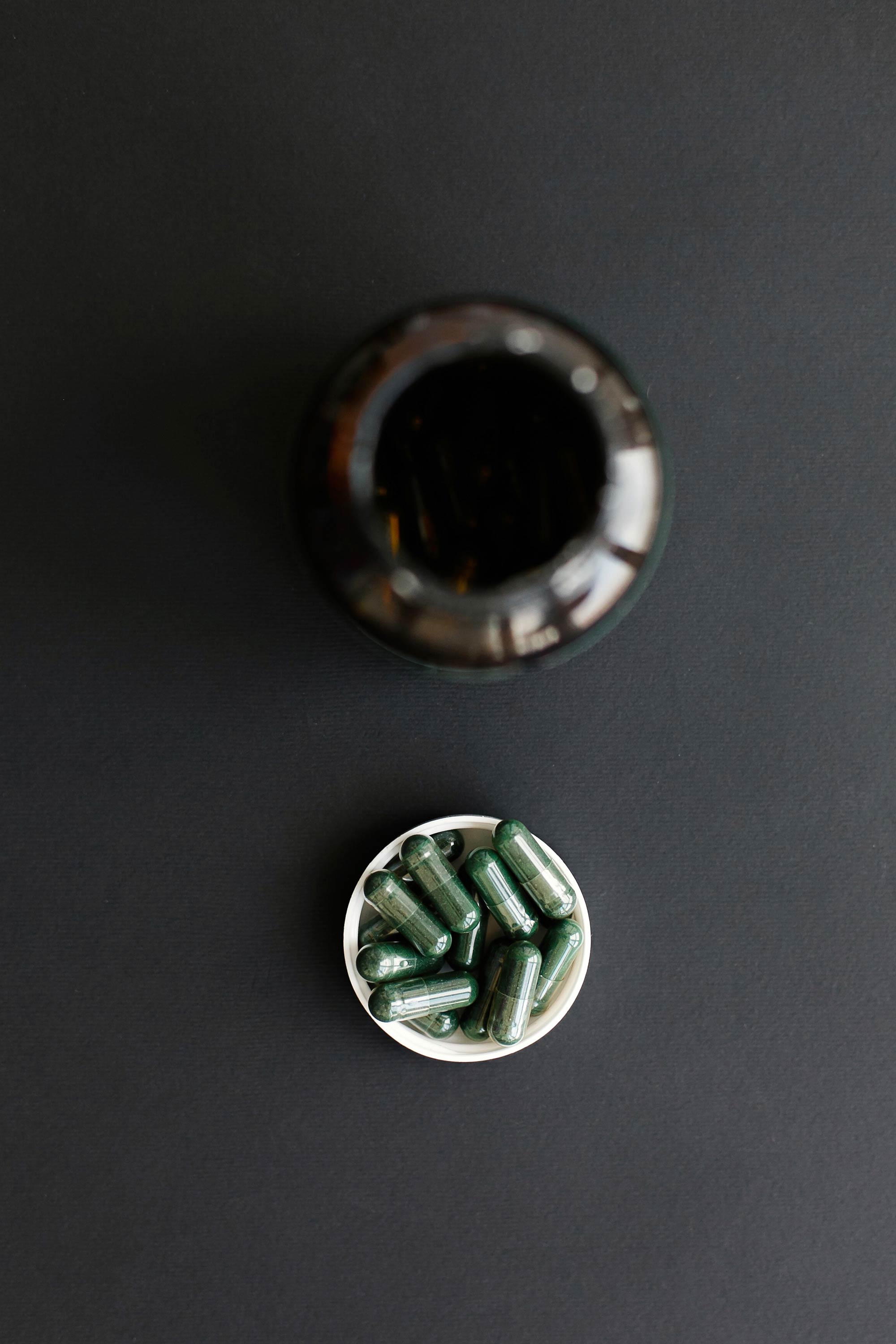 Abstract swirling patterns of teal, dark blue, and hints of orange, resembling a fluid cosmic design.