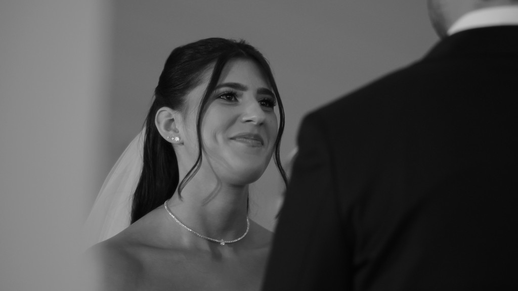 The bride is putting on her earrings.