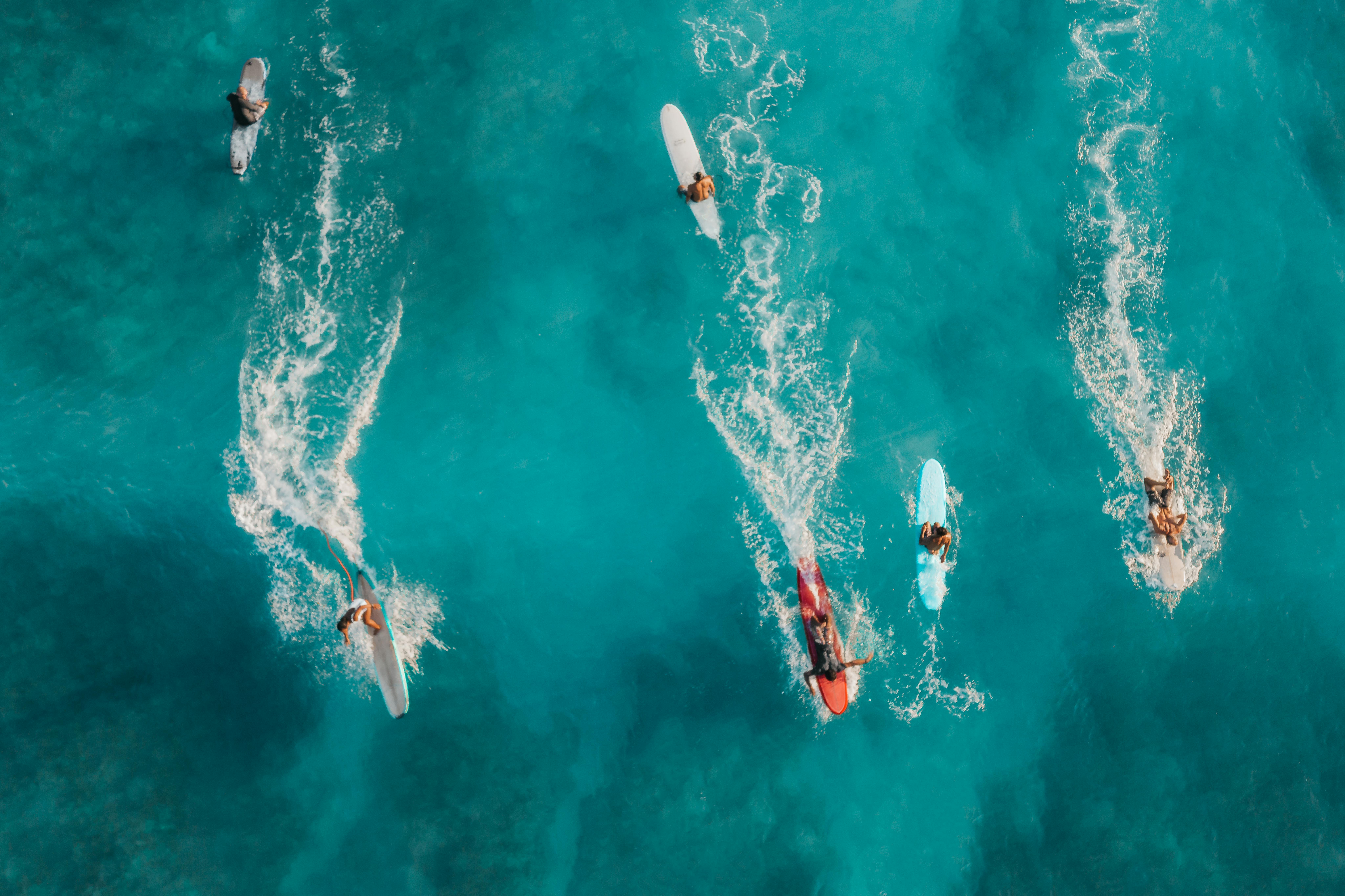 man surfing on sea waves during daytime
