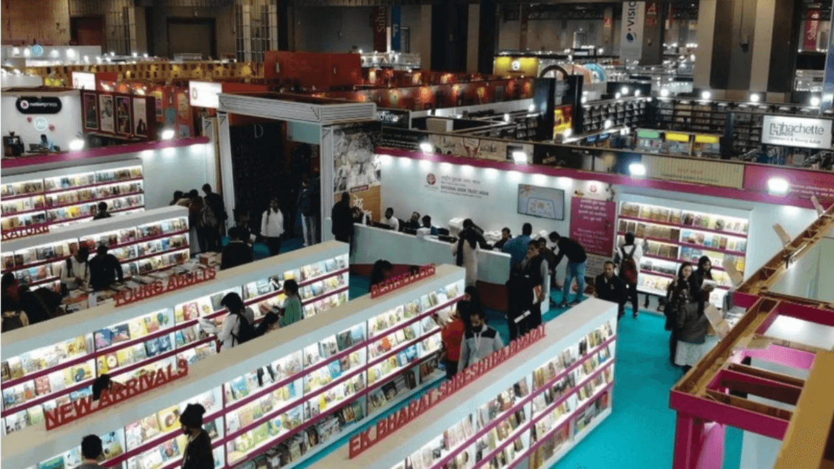 Vibrant expo hall at New Delhi World Book Fair with diverse visitors browsing 3,000+ stalls of publishers, authors signing books, colorful displays of fiction, children's books, and international titles amid cultural event banners.