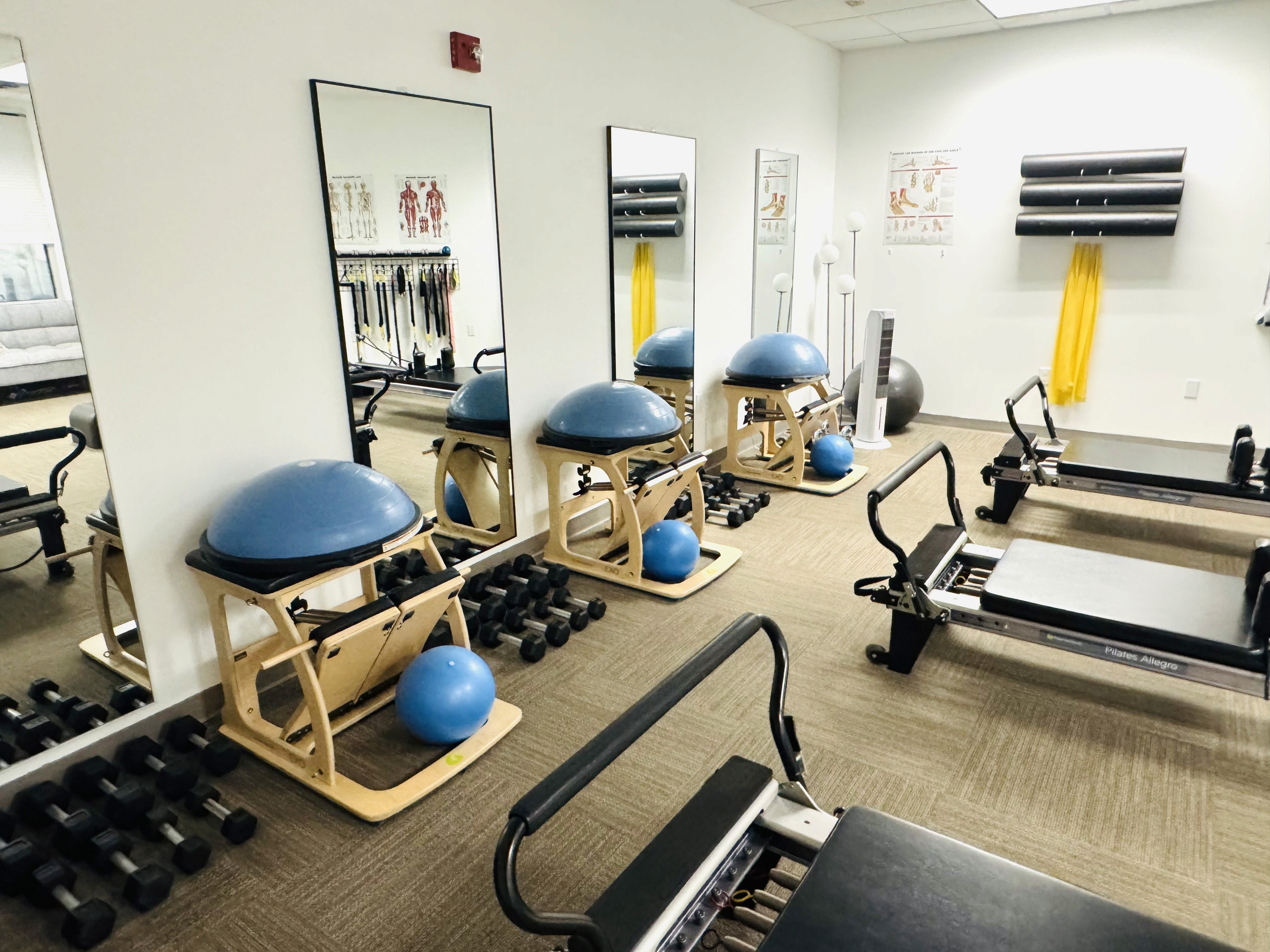 a woman is doing a piyoma exercise in a gym