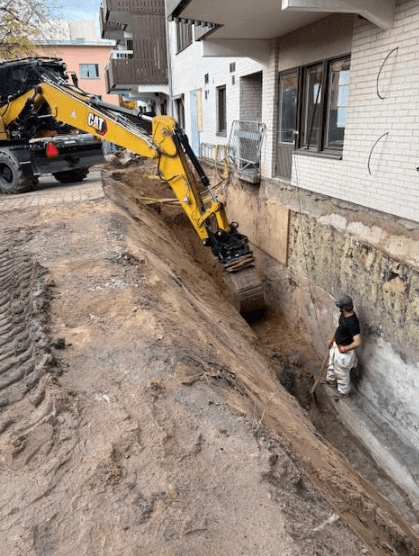 black and yellow heavy equipment on brown rock formation during daytime
