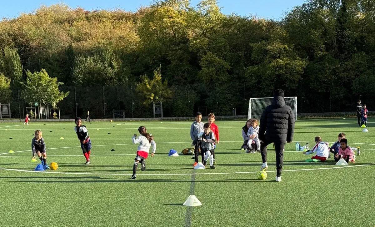 Kids being coached at football
