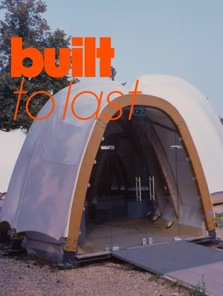 Curved modular structure with an arched entrance, emphasizing durability, construction, and functional design.