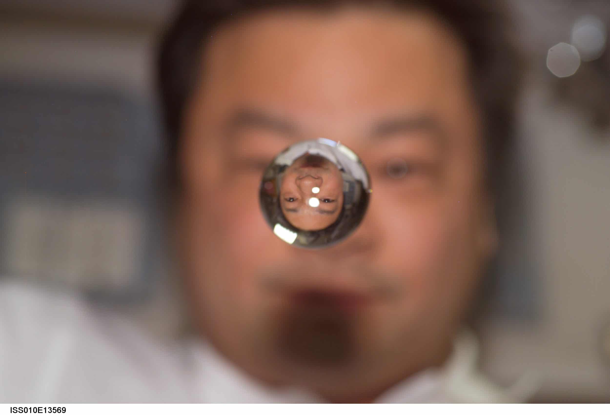 An astronaut with a water droplet in space.