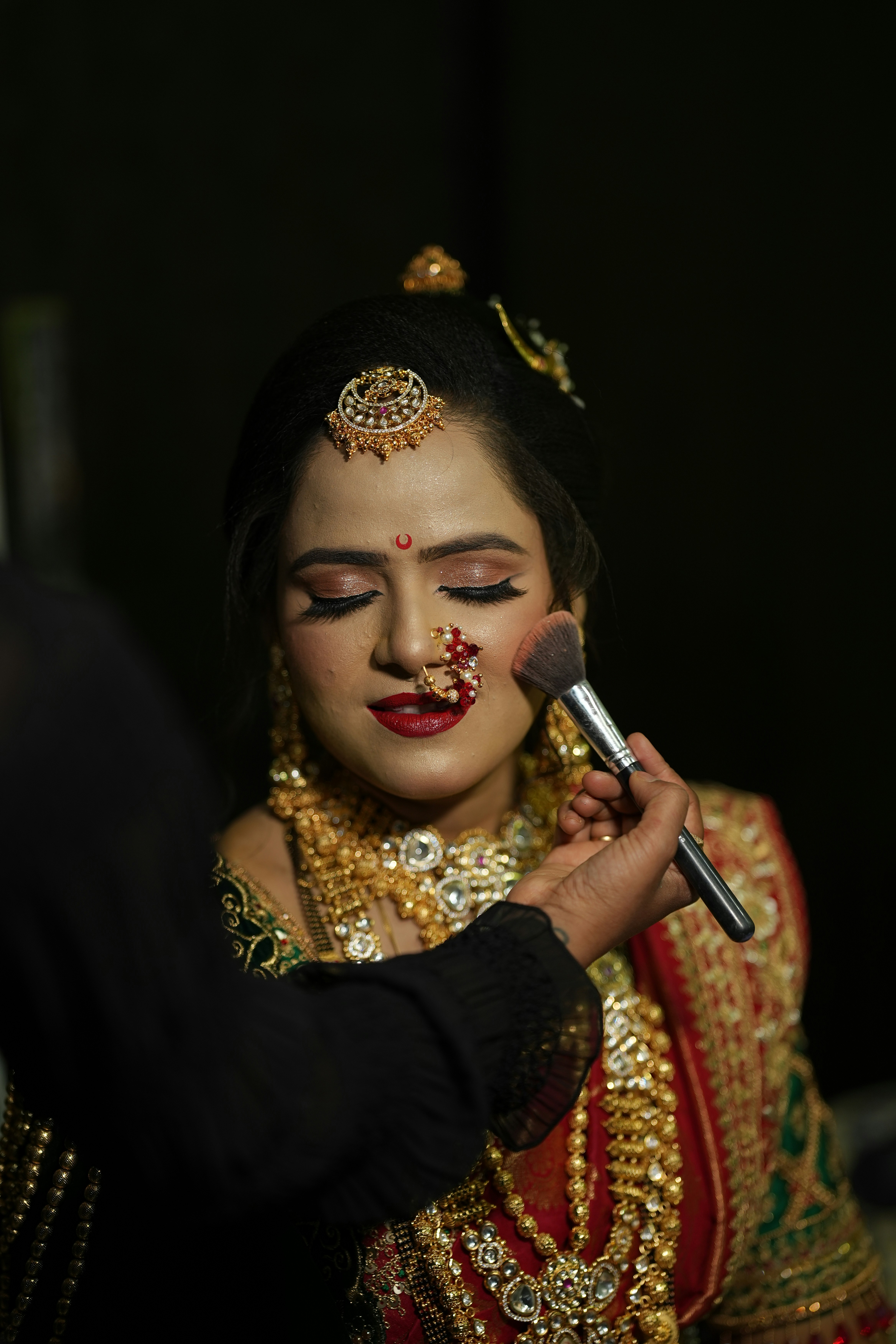 a bride getting her makeup done by a makeup artist