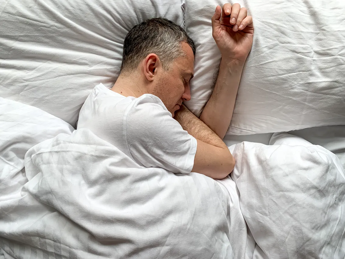 man with grey hair sleeping