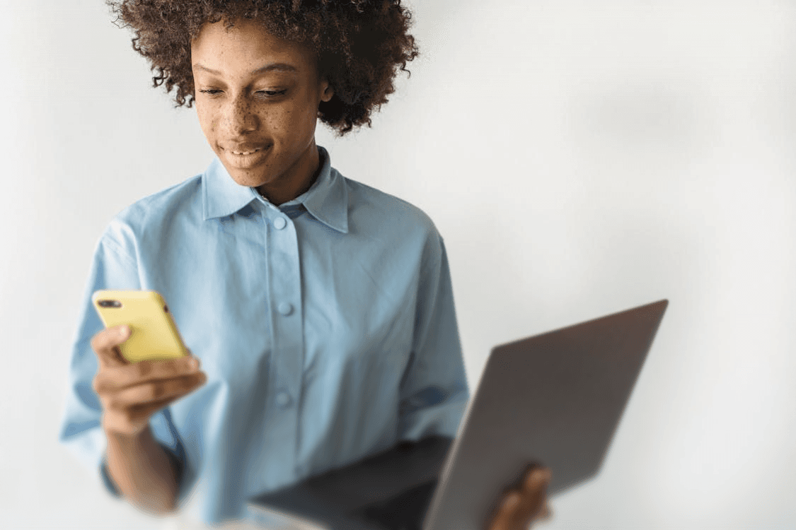 A young lady using devices at workplace