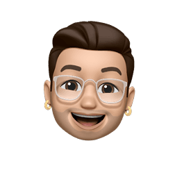 Smiling Memoji with brown hair, glasses, and gold earrings.