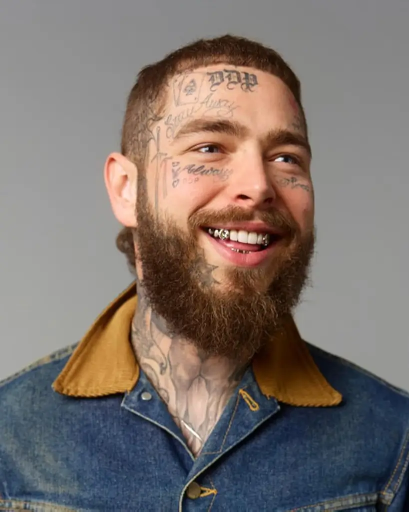 MrBeast, a young man with short hair wearing a black t-shirt, looking thoughtfully to the side against a gray background.