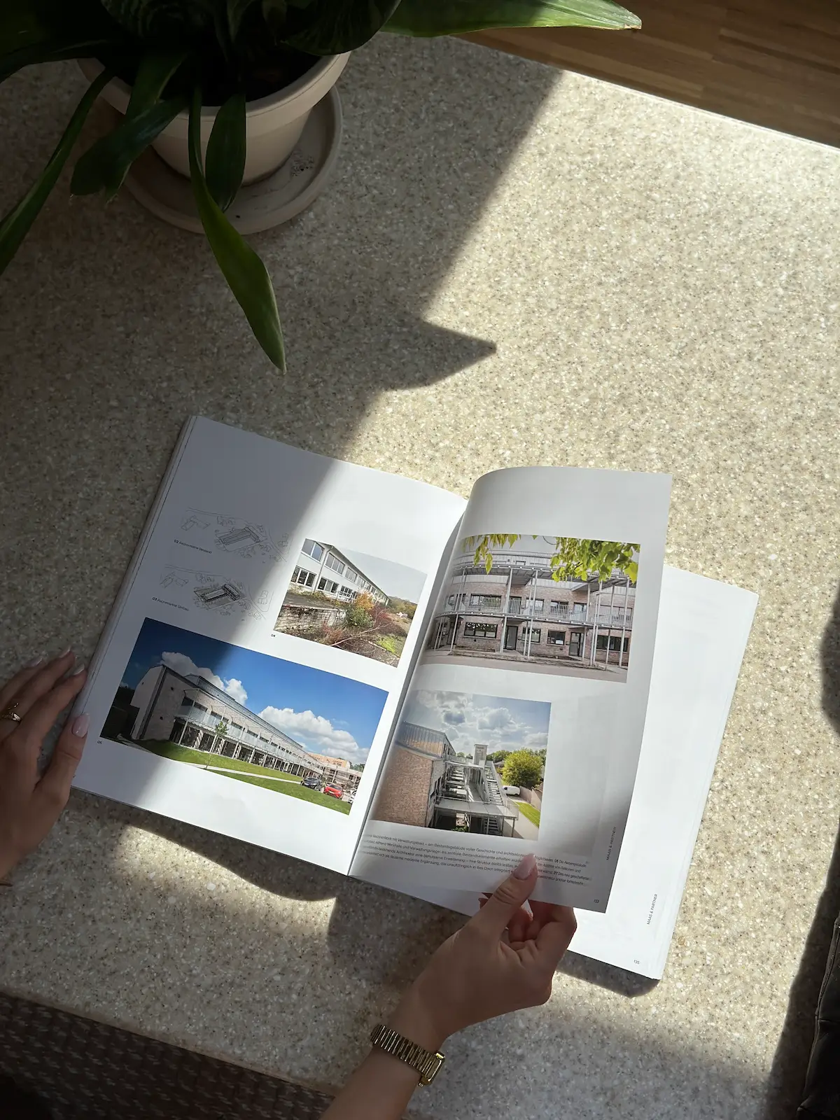 Längliches Wohngebäude mit Klinkerfassade, großen Fenstern und Balkonen über zwei Etagen