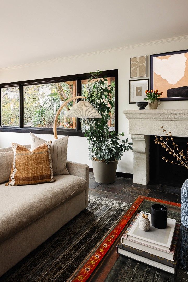 Luxury interior home design, grand centered limestone fireplace with timber accent beam focal point