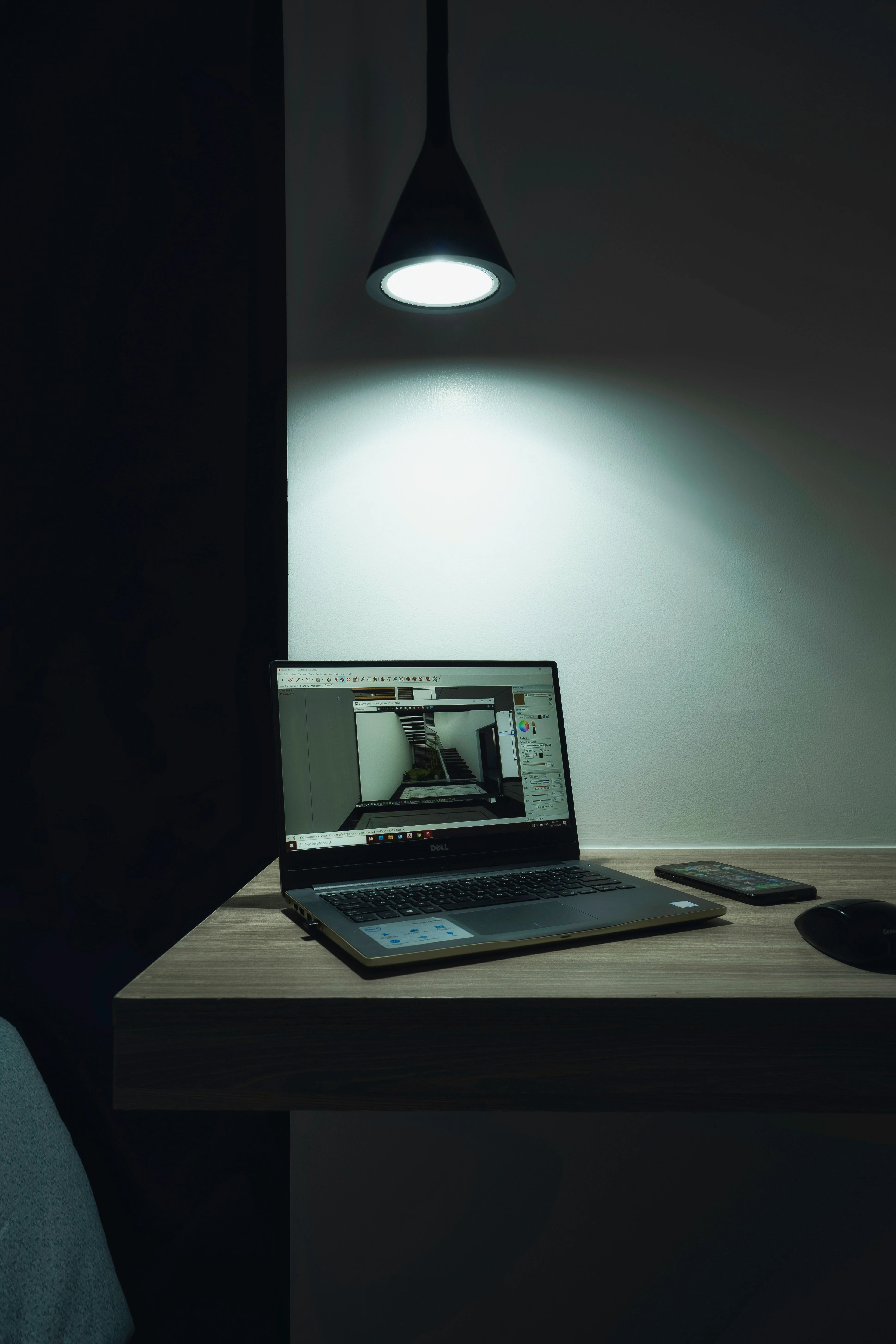 laptop on desk in dimly lit room