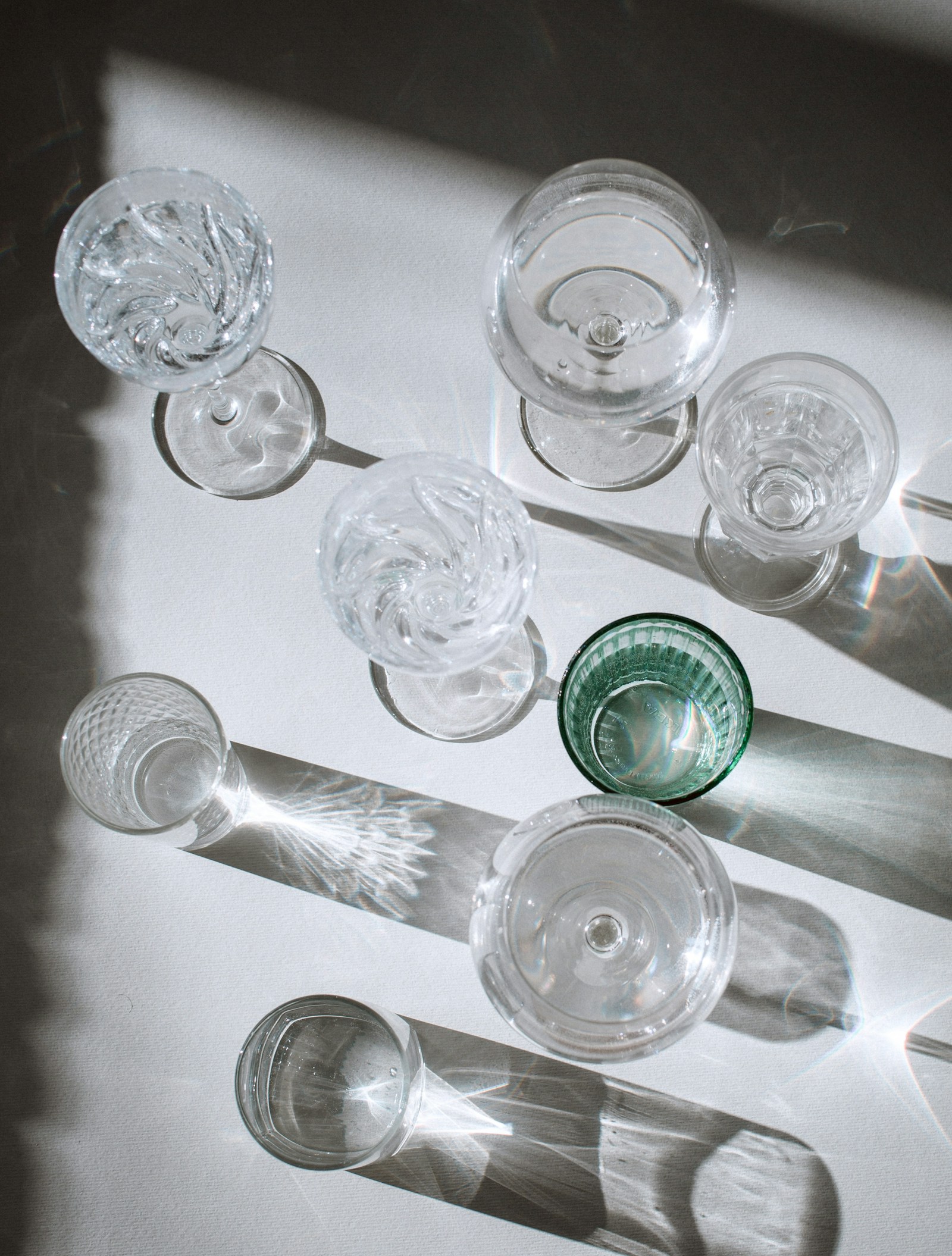 Clear glass cup on white table — editorial still life image 1 for "Objects in Repose"