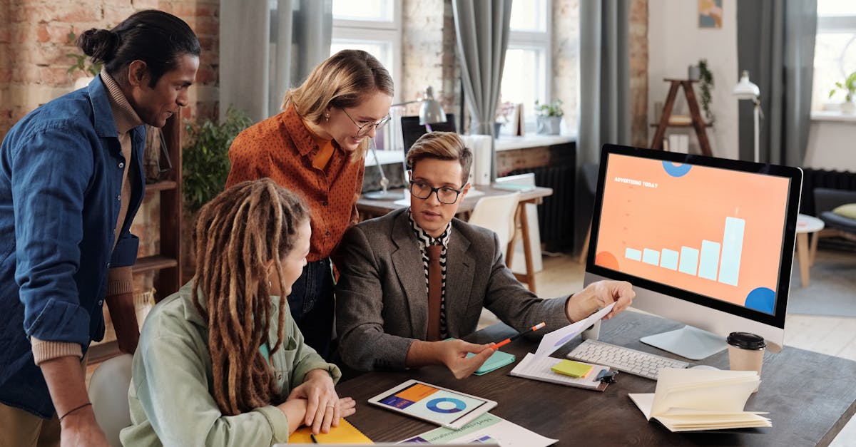 A group of diverse professionals discussing digital marketing plans in a modern office setting.